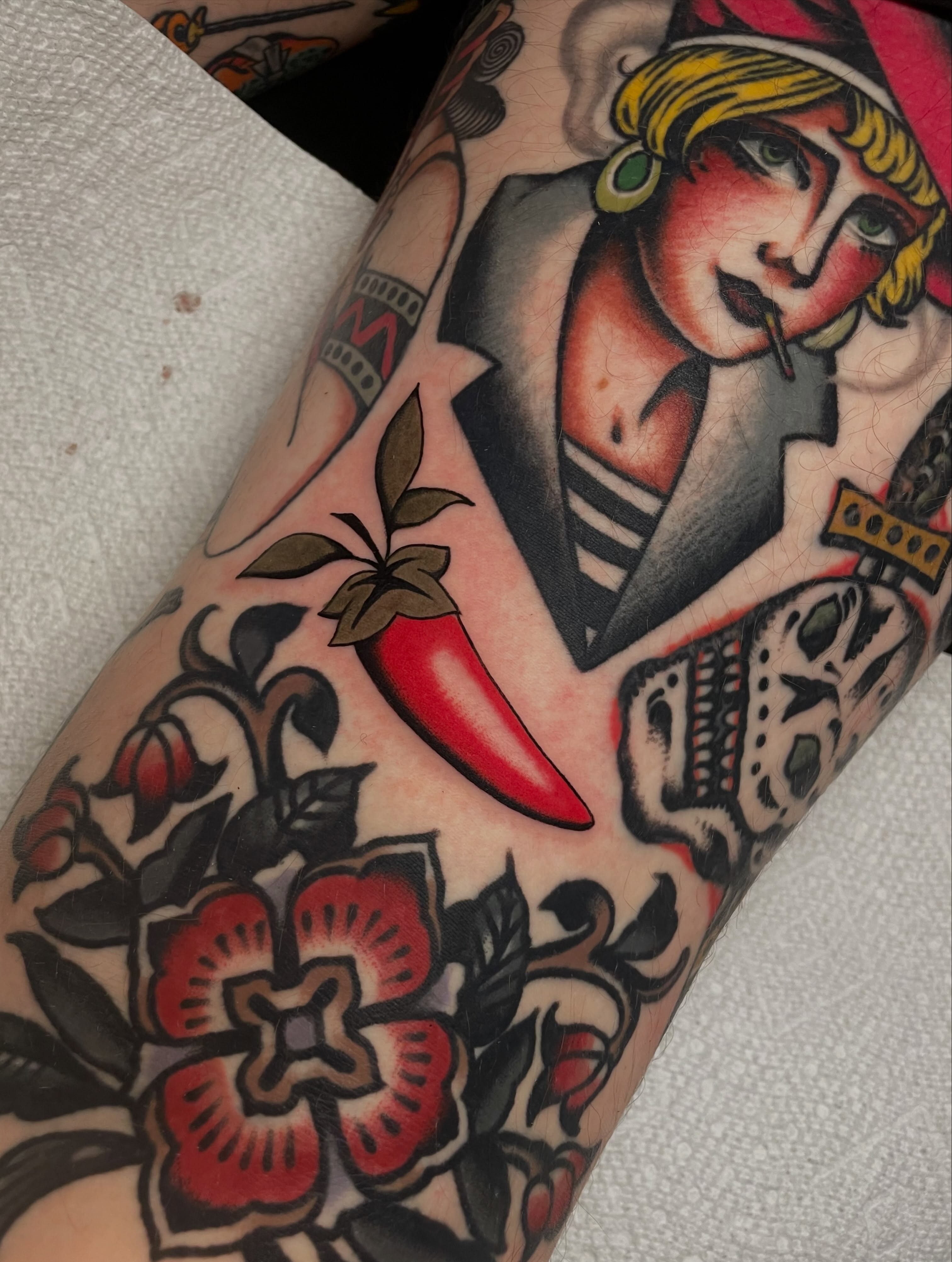 Woman with chili pepper American traditional tattoo on the forearm by Toulouse Noble, Portland, Oregon