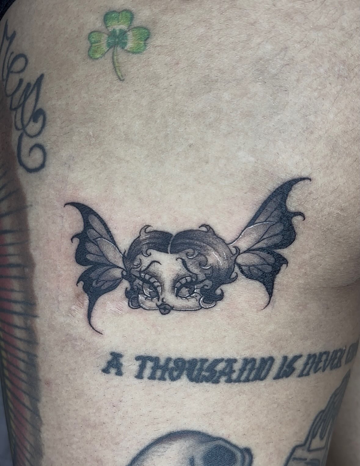 Butterfly black and grey tattoo on the upper arm by Weho Tattoo Artist Lupe