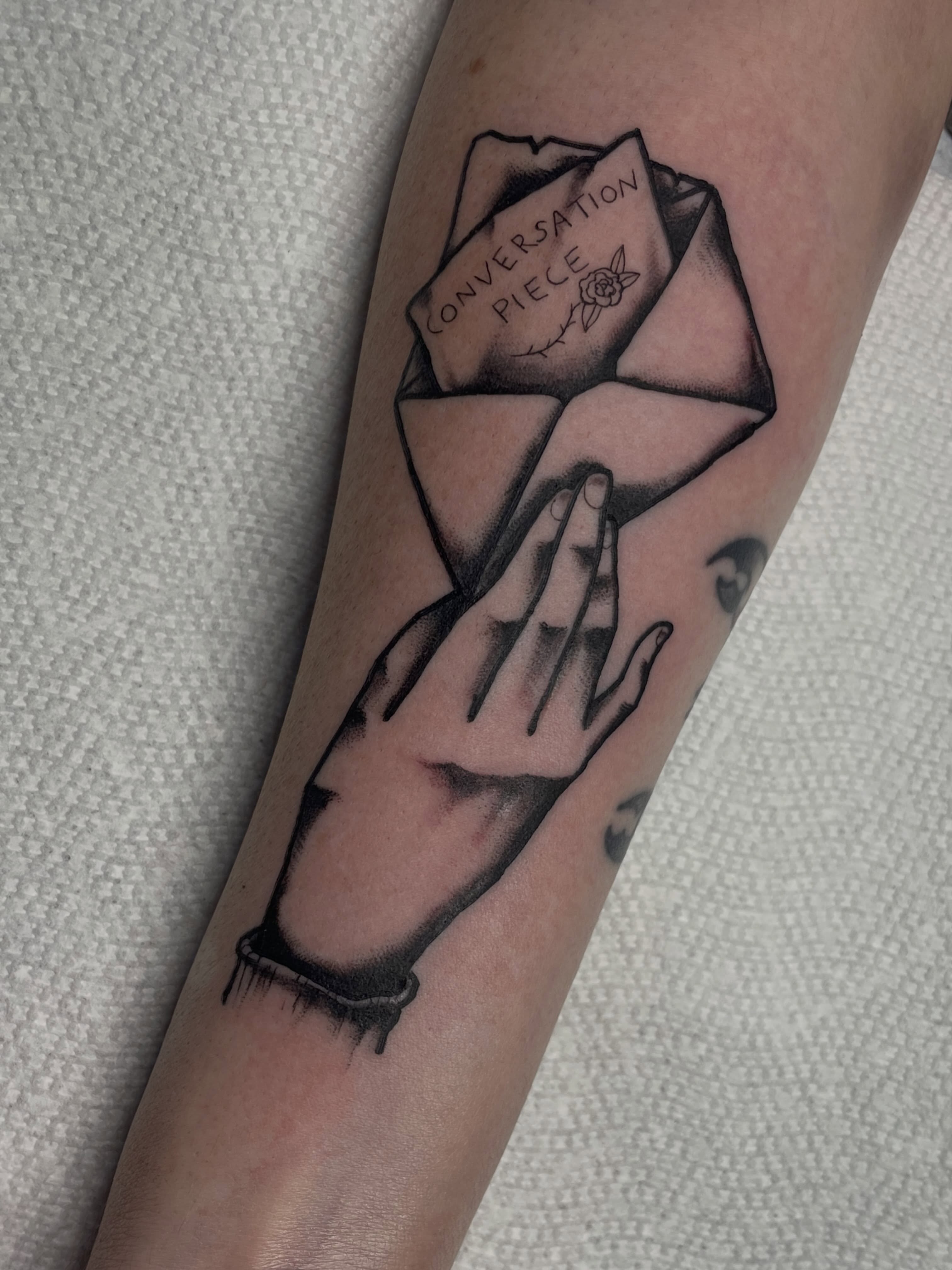 Conversation piece realism tattoo on the forearm by G. Clover ⚧︎, Chicago, Illinois