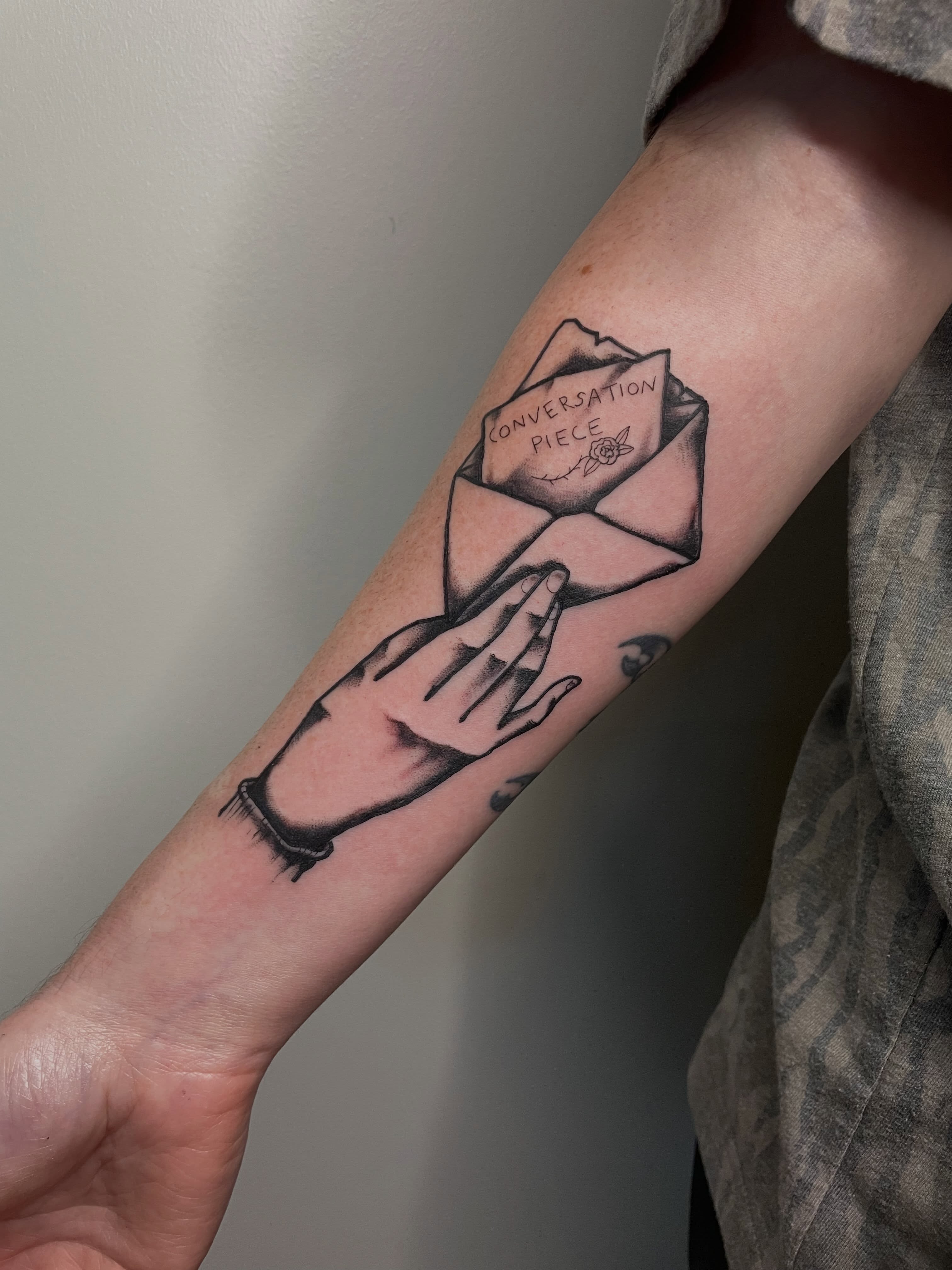 Rose in envelope black and grey tattoo on the forearm by G. Clover ⚧︎, Chicago, Illinois