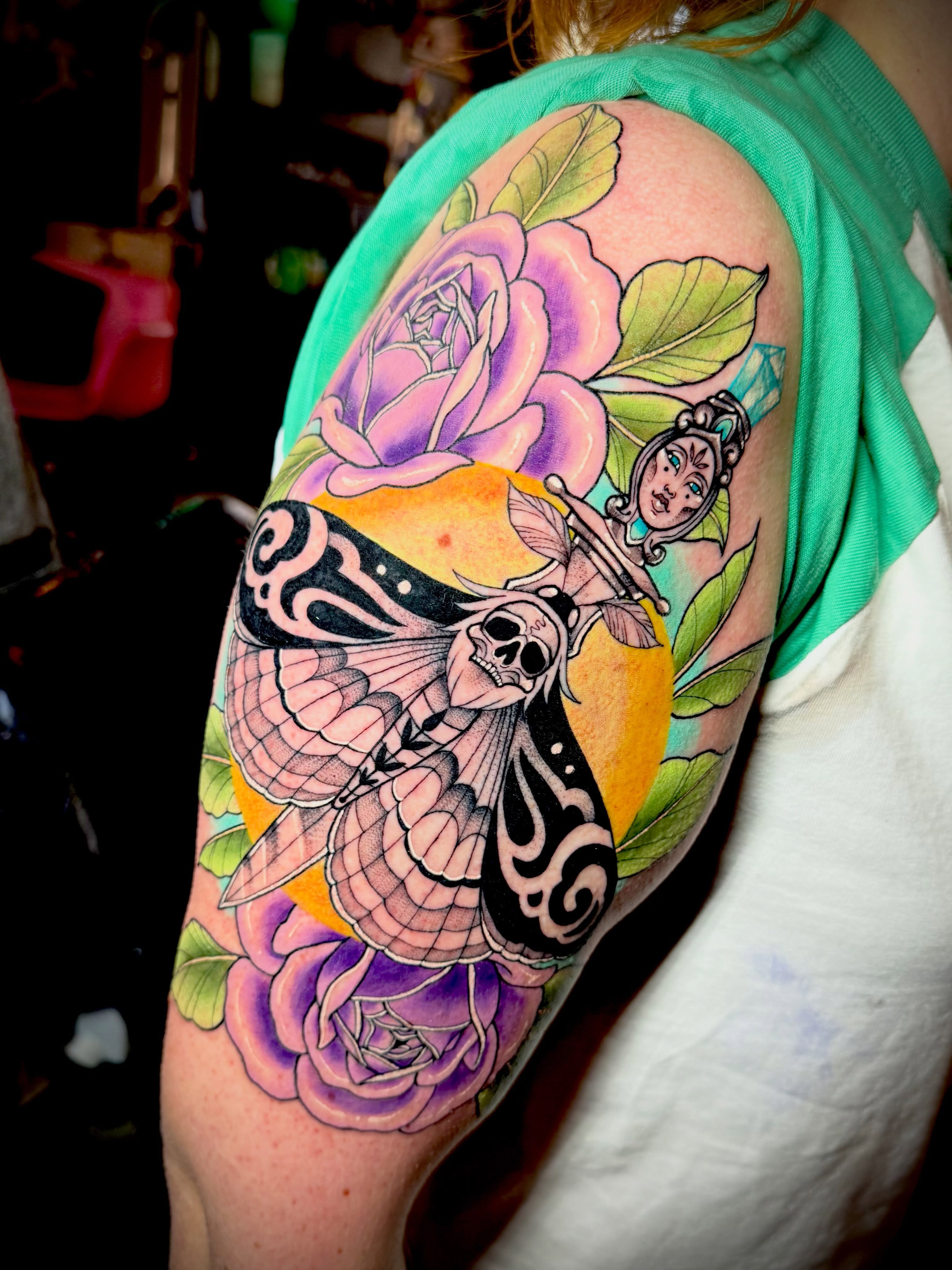 Butterfly and roses American traditional tattoo on the shoulder by Emily Emani, Fremont, Ohio