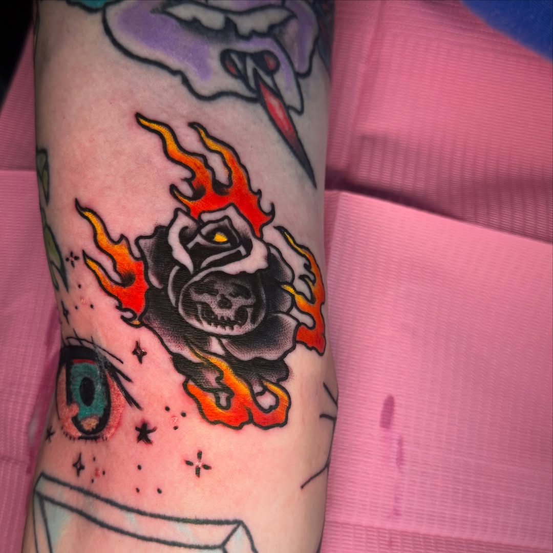 Flaming rose American traditional tattoo on the forearm by Arron Albaugh