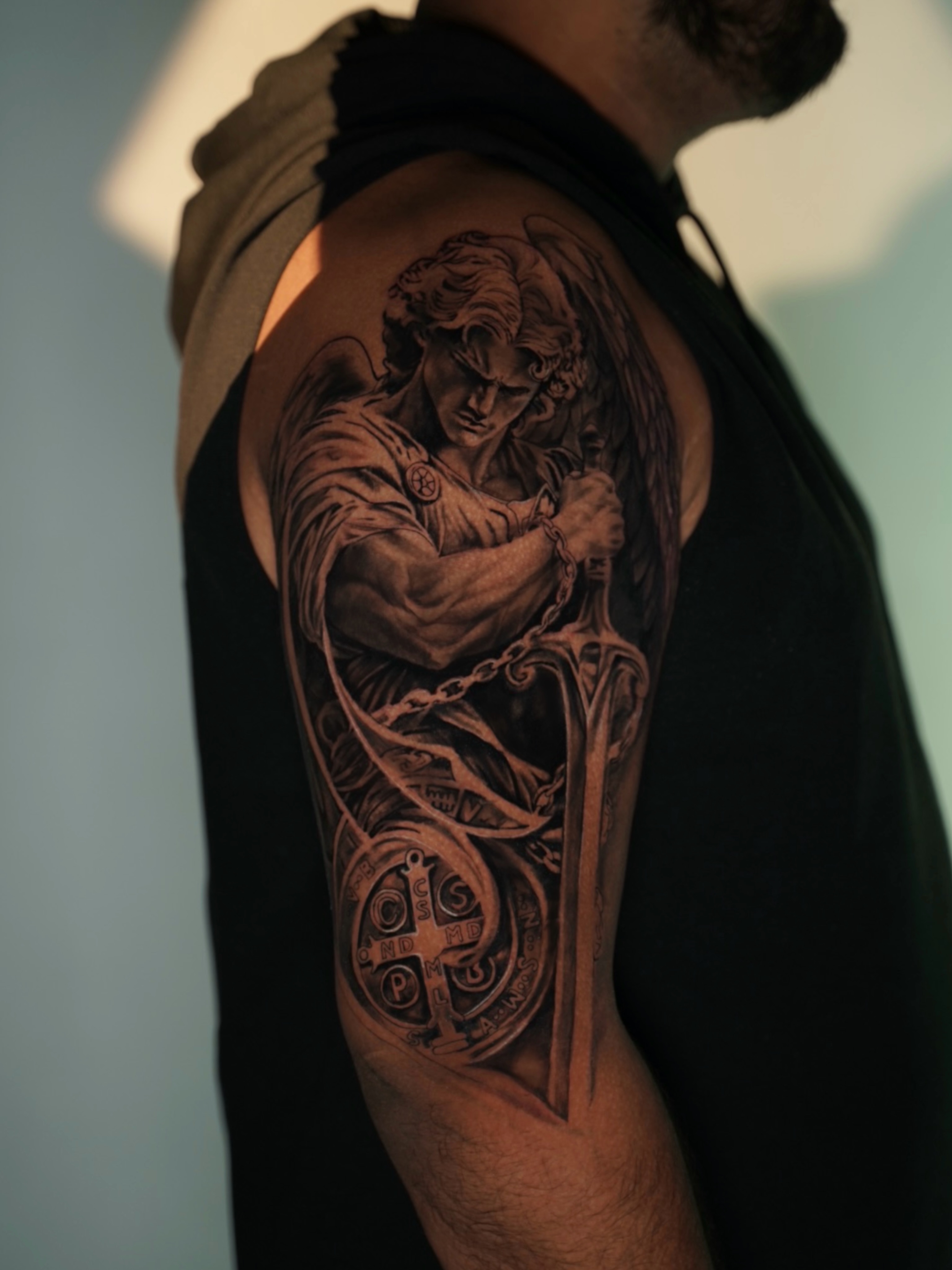 Angel with sword realism tattoo on the upper arm by Diego Andrés Cárdenas