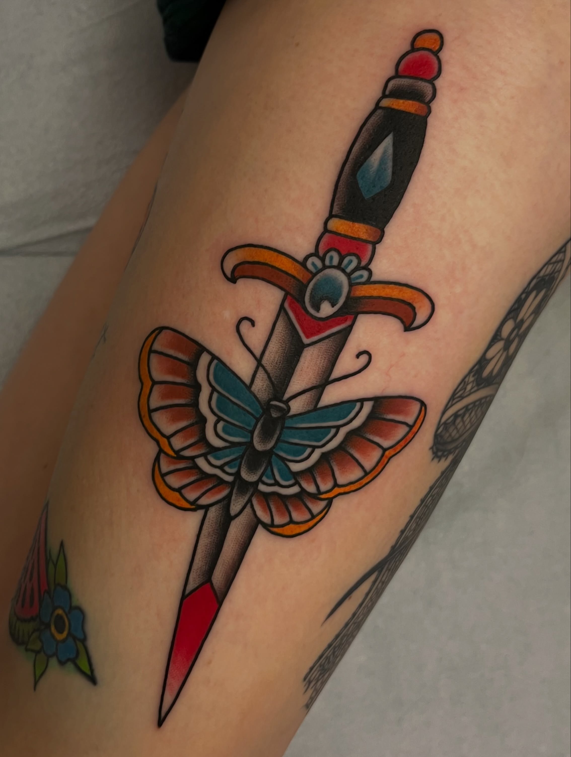 Sword and butterfly American traditional tattoo on the forearm by Anthony Tattooer, Seattle, Washington
