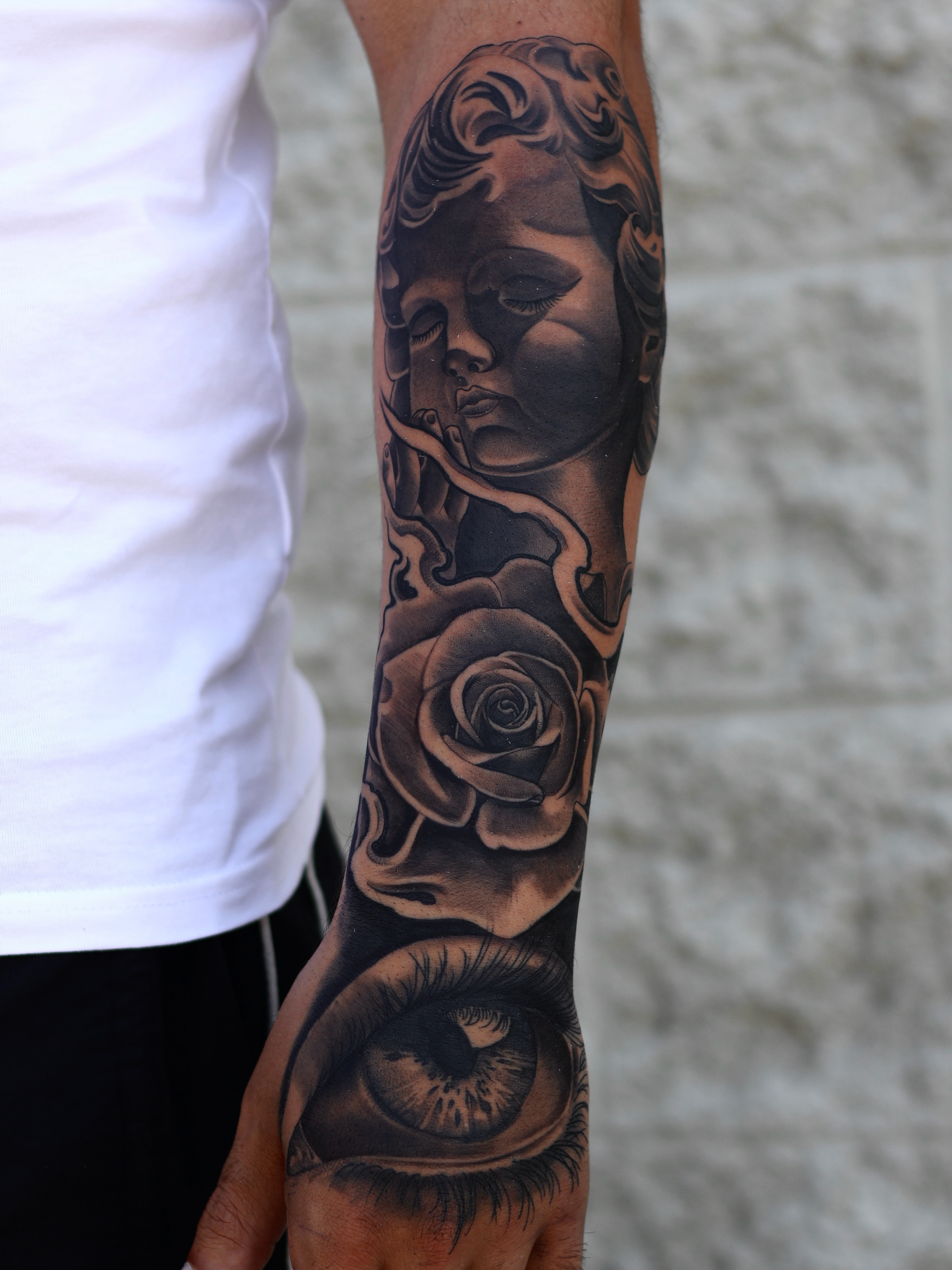 Woman's face and rose realism tattoo on the forearm by San Diego Tattoo Artist