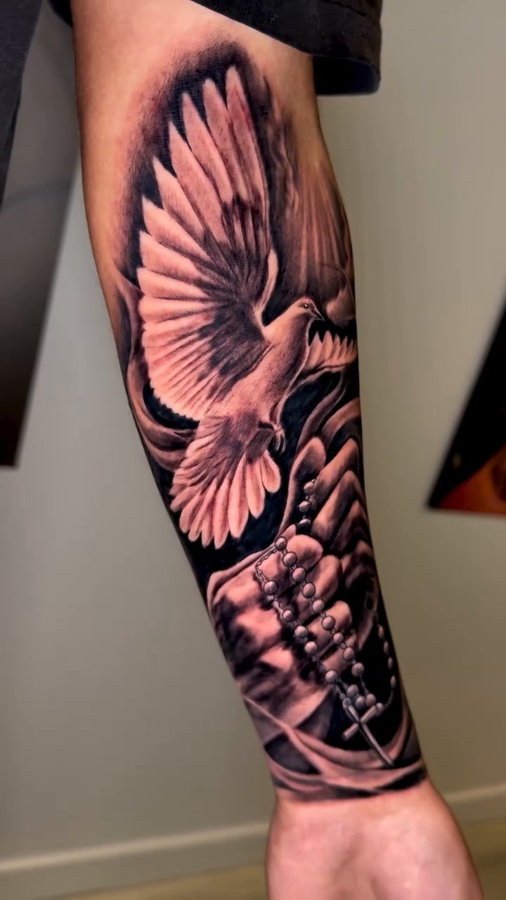 Dove with religious elements realism tattoo by Brandon Patino