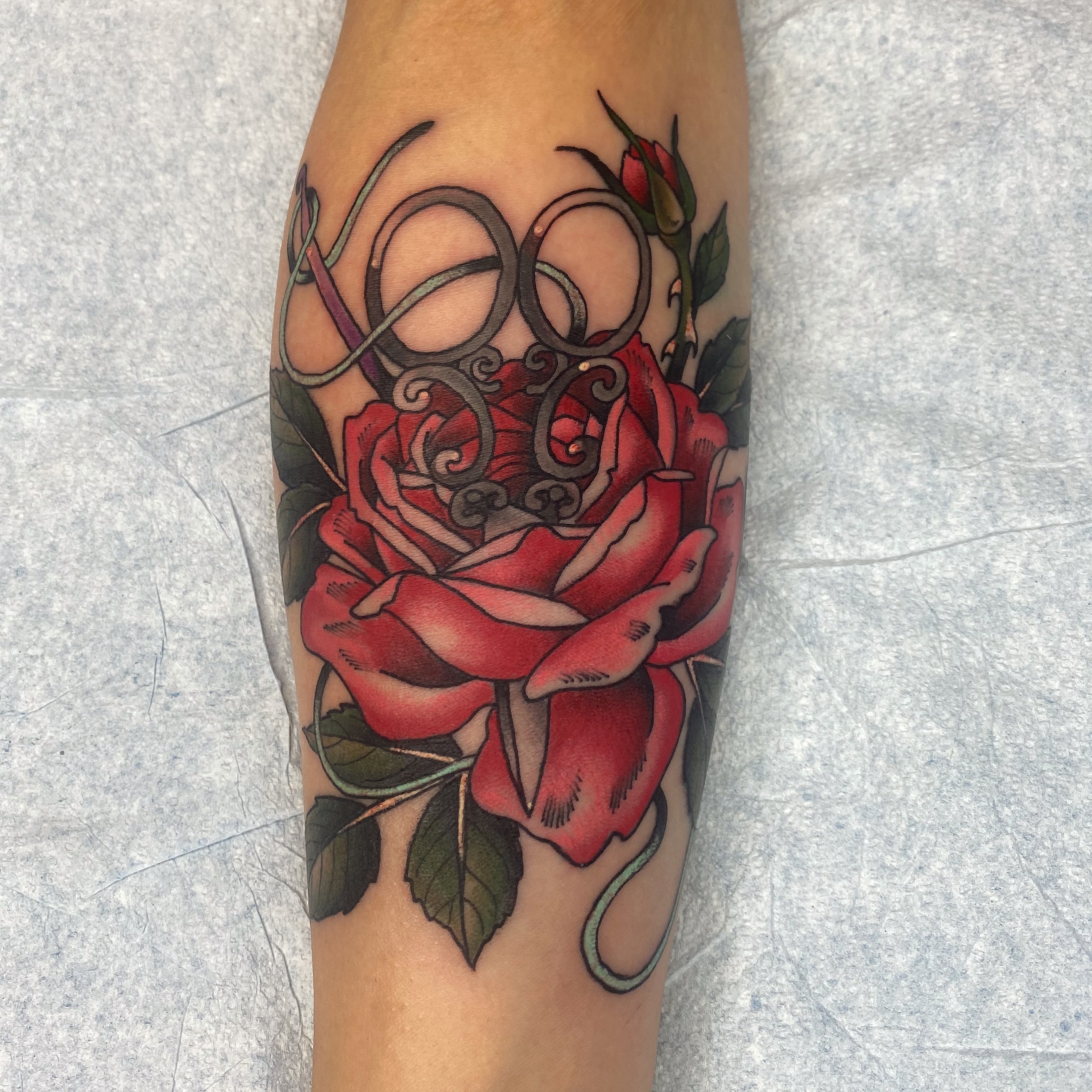 Red rose realism tattoo on the forearm by Adam Bailey, Portland, Oregon
