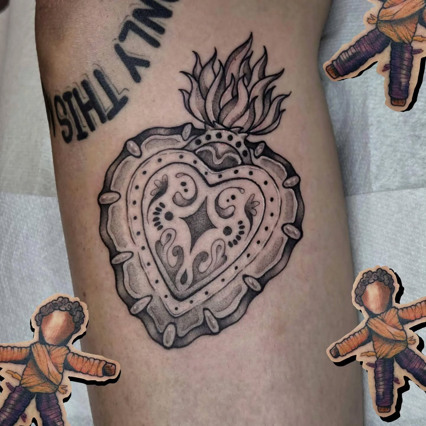 Heart with flames black and grey tattoo on the forearm by alec