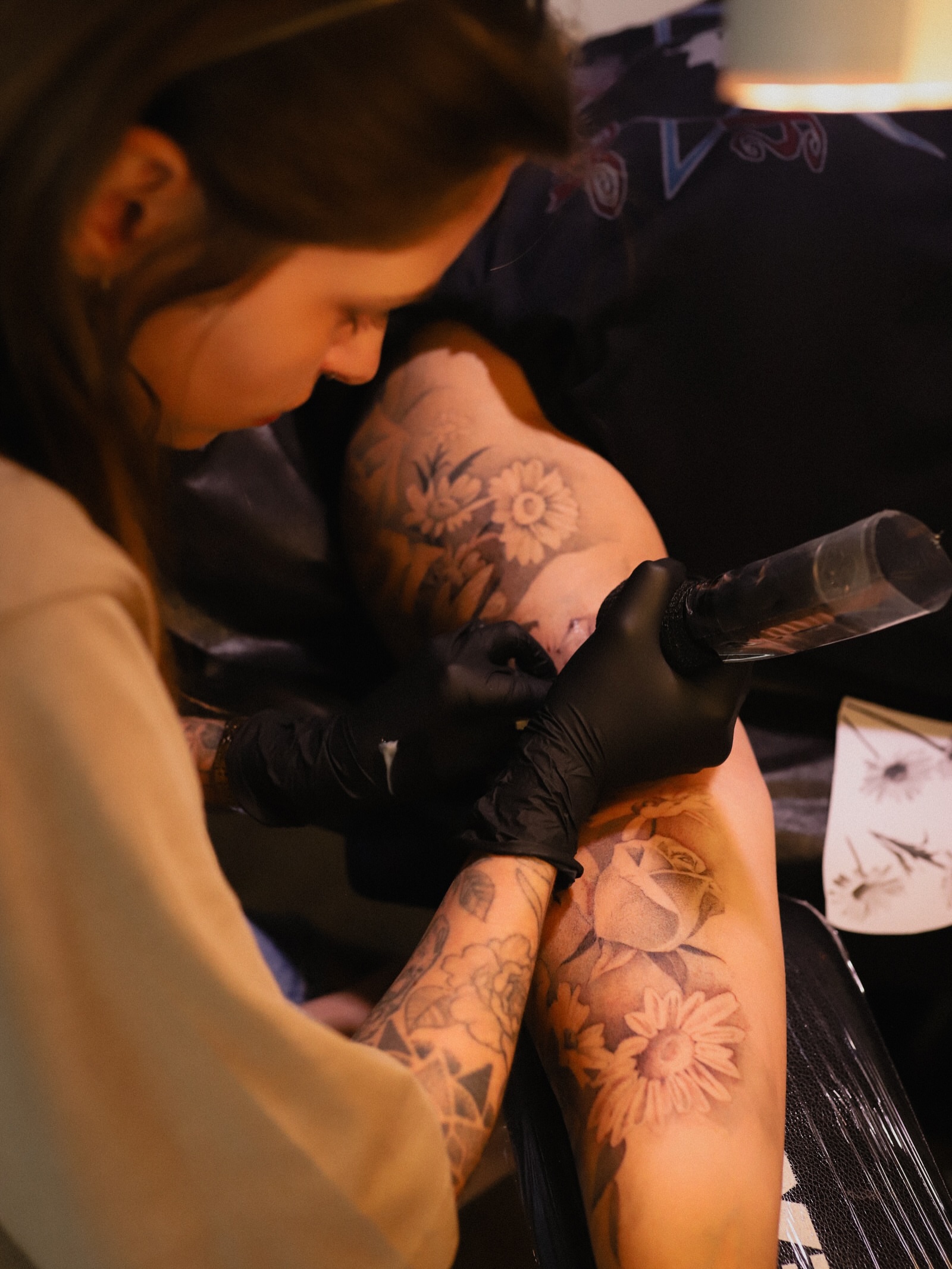 Floral bouquet black and grey tattoo on the forearm by Keely Thompson