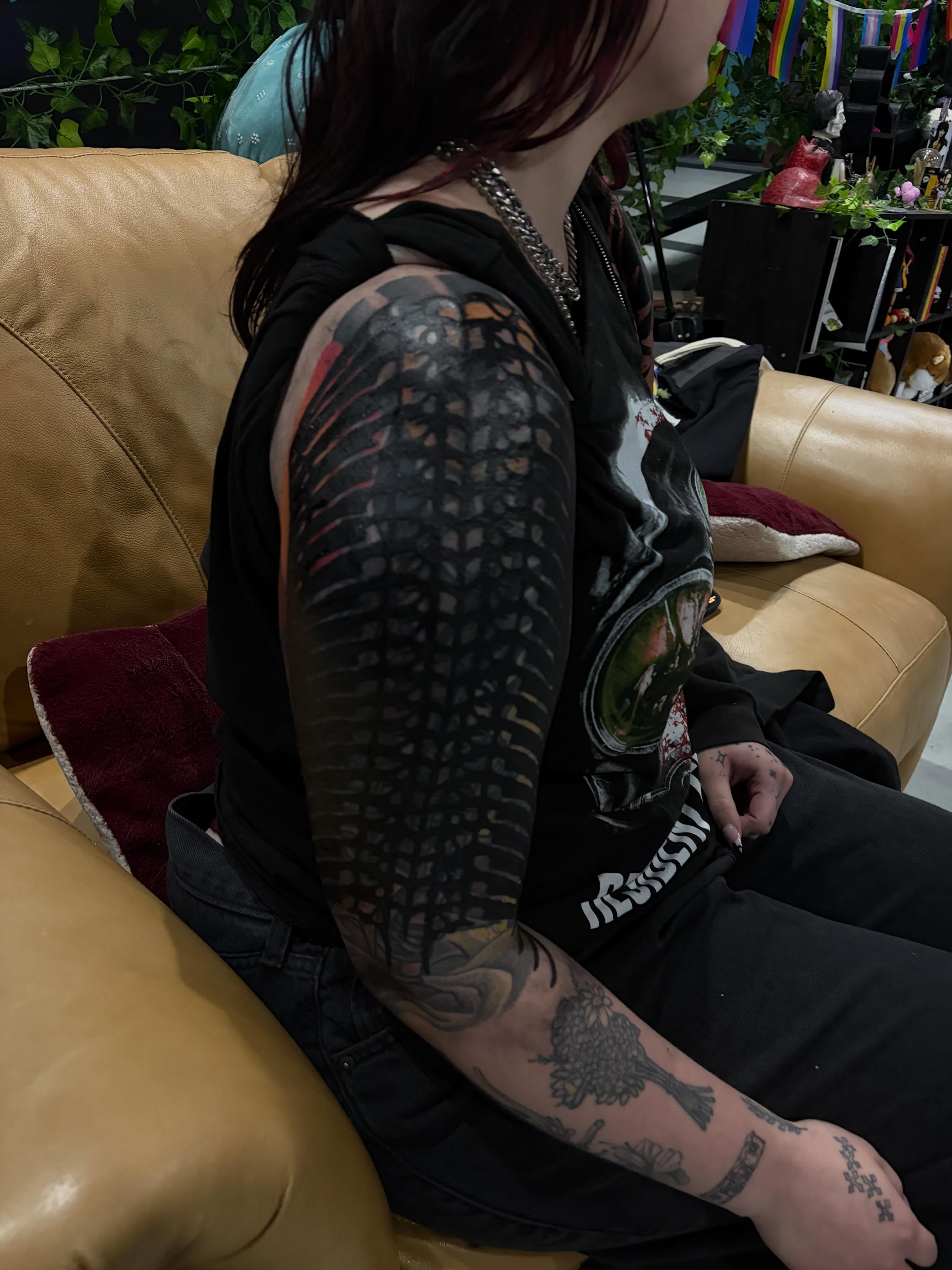Bird black and grey tattoo on the upper arm by neal