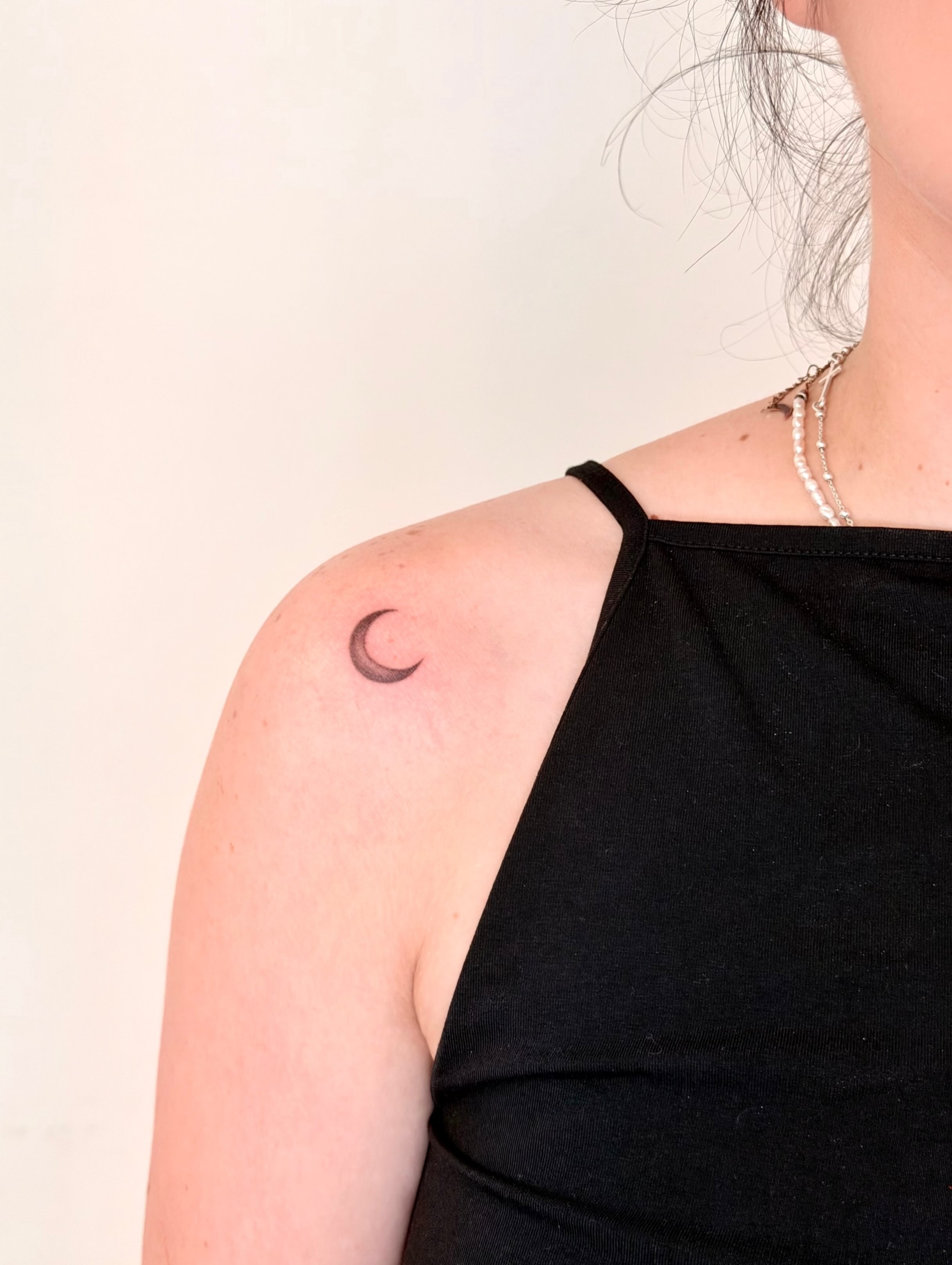 Moon black and grey tattoo on the shoulder by Fine Line Tattoo Artist