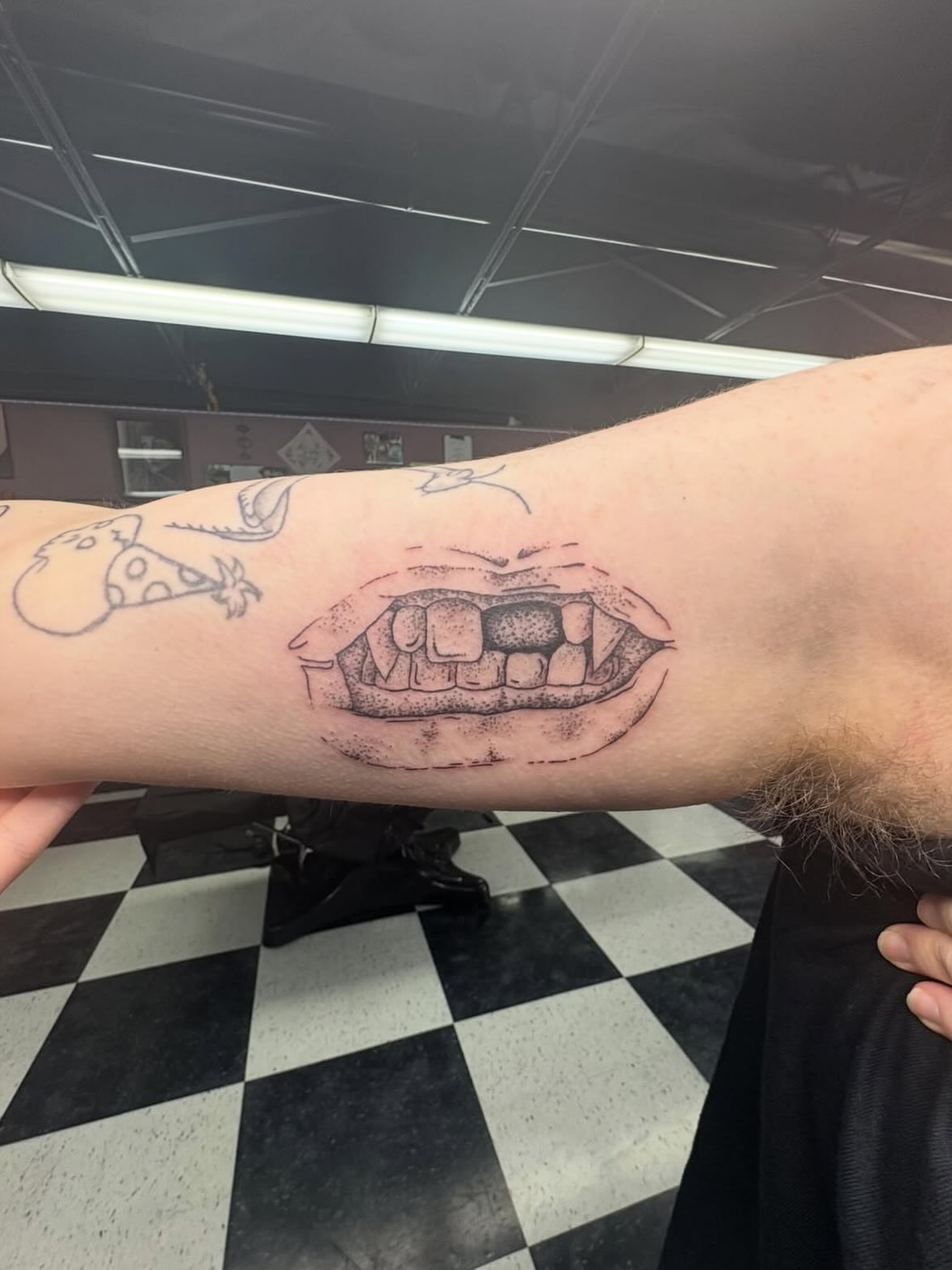 Angry mouth dotwork tattoo on the forearm by Joe ⋆₊⋆☢︎⁺₊⚠︎₊⋆
