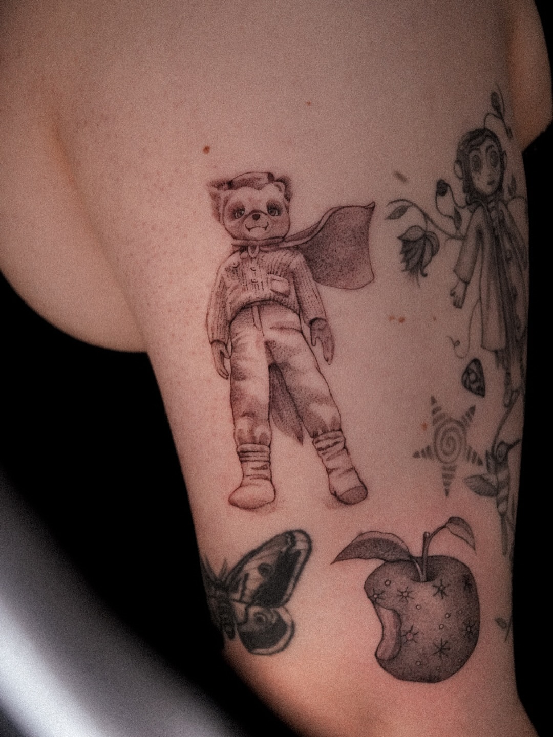 Astronaut teddy bear black and grey tattoo on the forearm by Joy Christiana