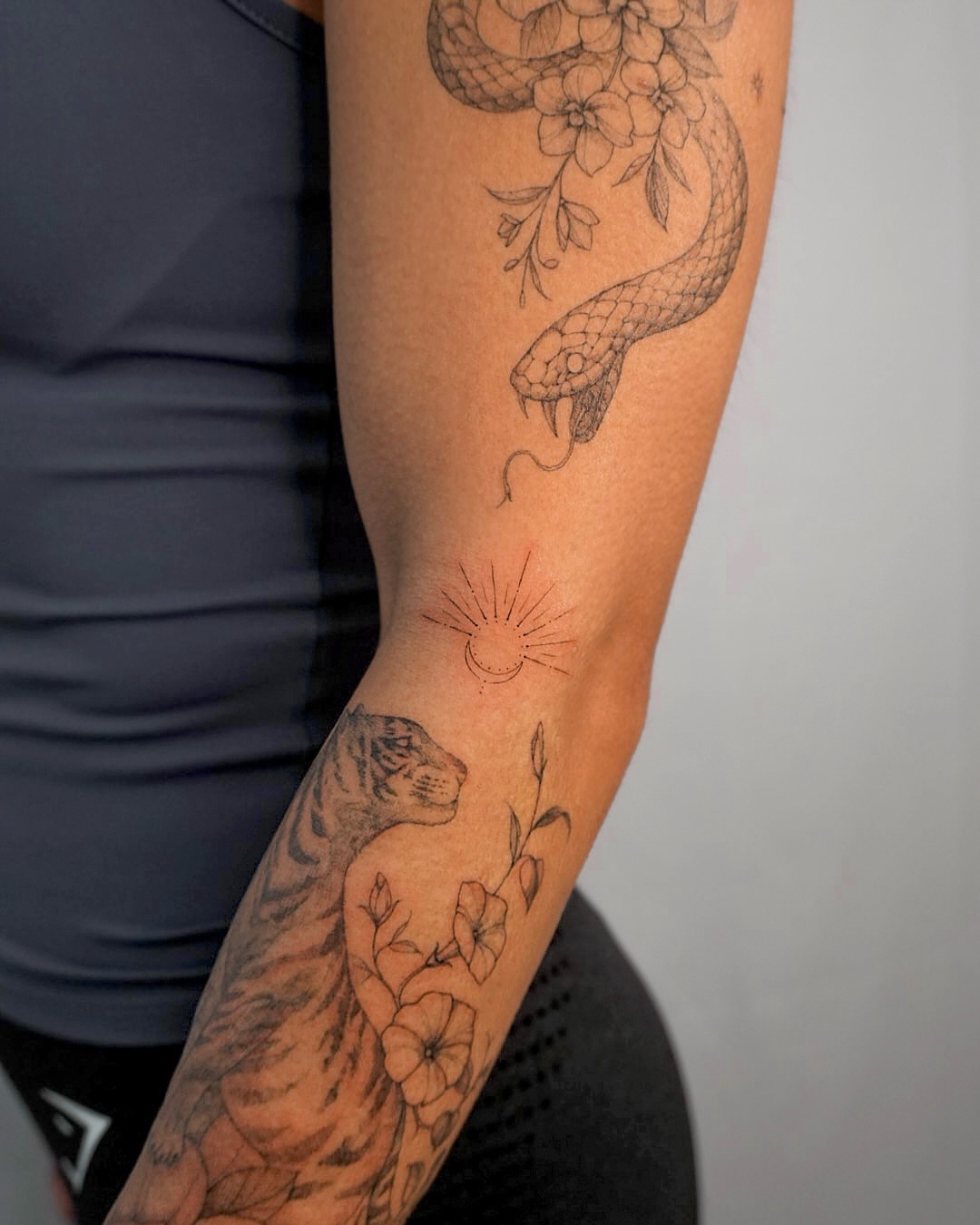 Snake and tiger black and grey tattoo on the forearm by Hyn[hin]