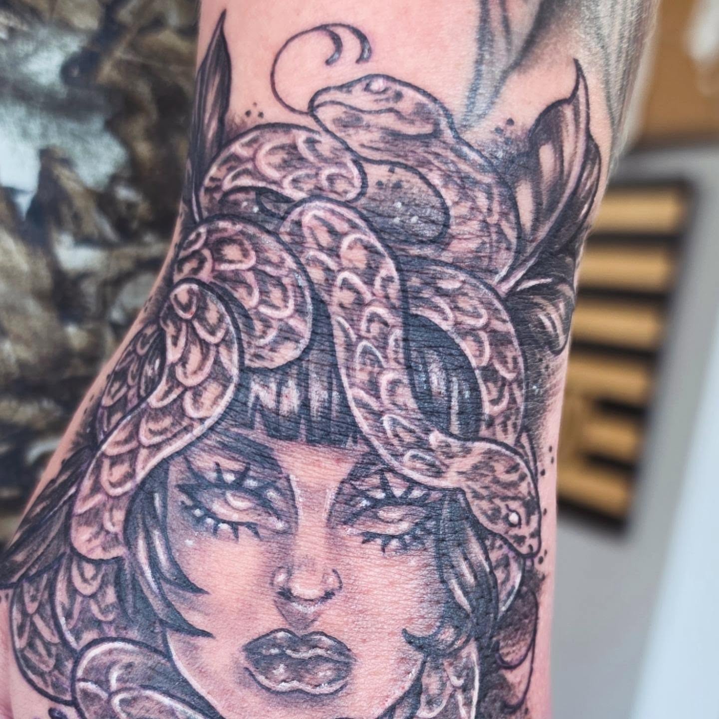 Woman with snakes American traditional tattoo on the forearm by Colleen