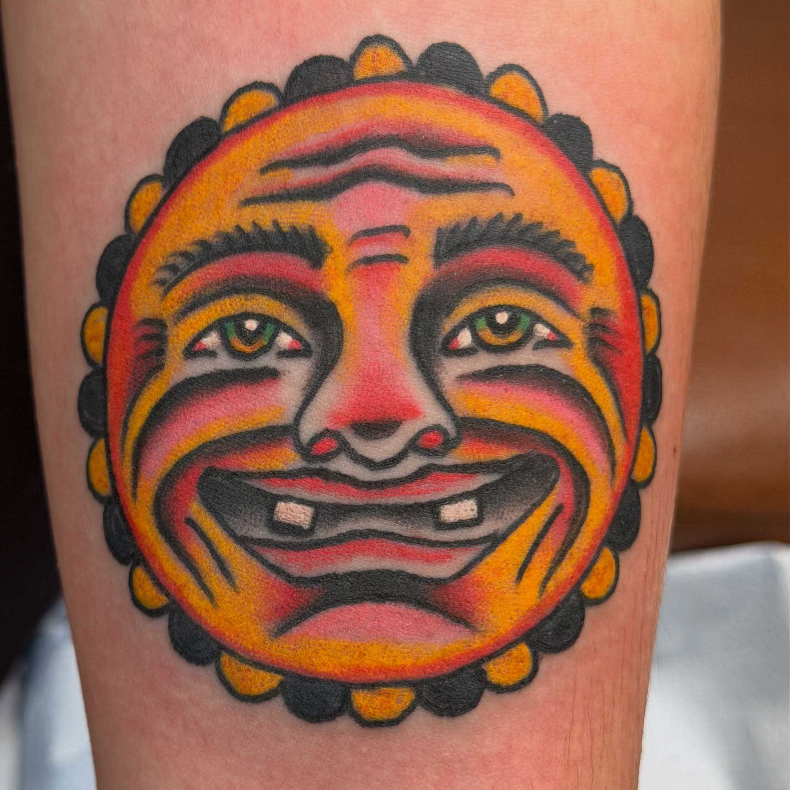 Jester face American traditional tattoo on the forearm by dave rash