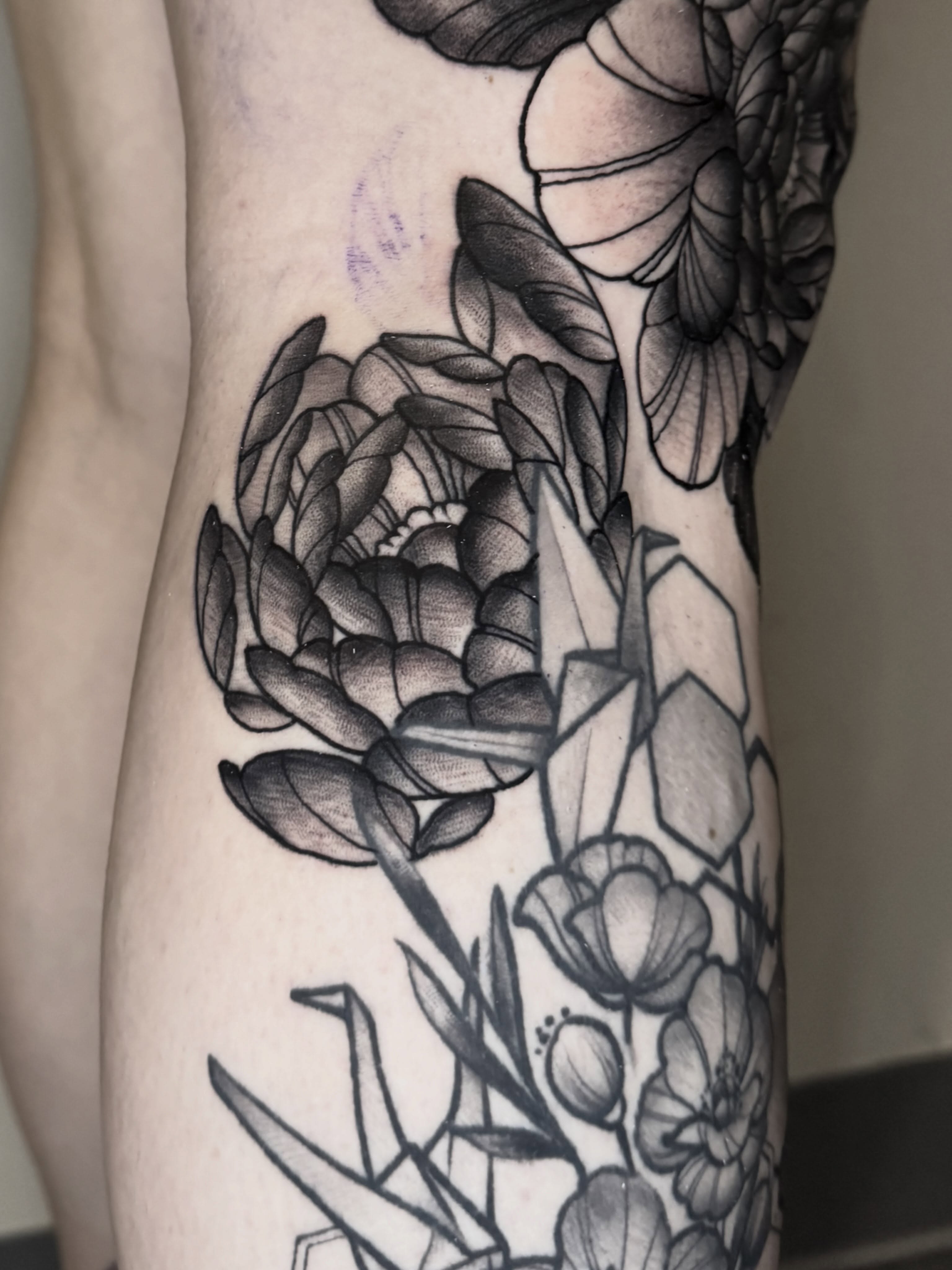 Floral arrangement geometric tattoo on the forearm by Mike Bean, Minneapolis, Minnesota