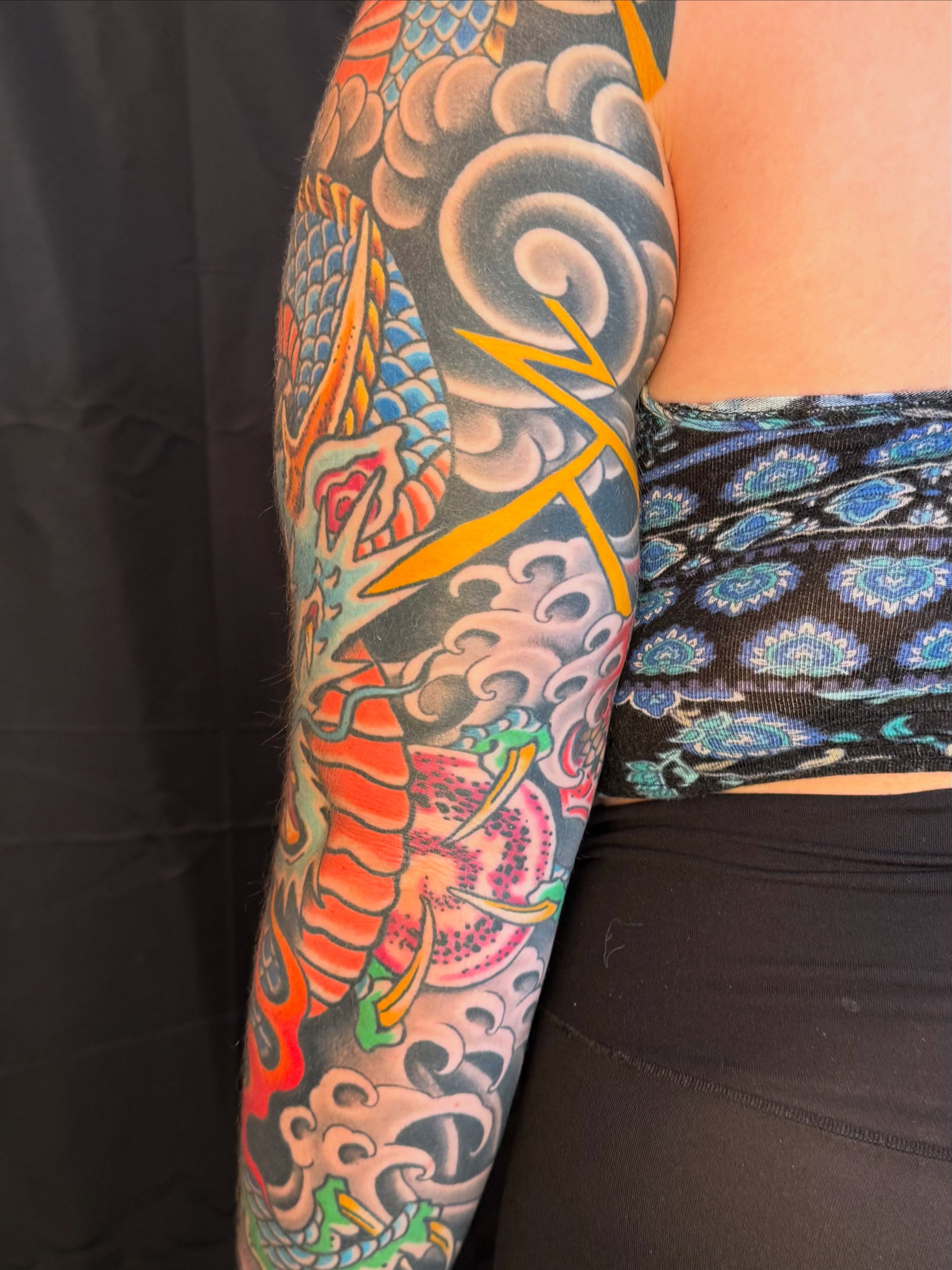 Koi fish and clouds japanese irezumi tattoo on the upper arm by Noah Moretz