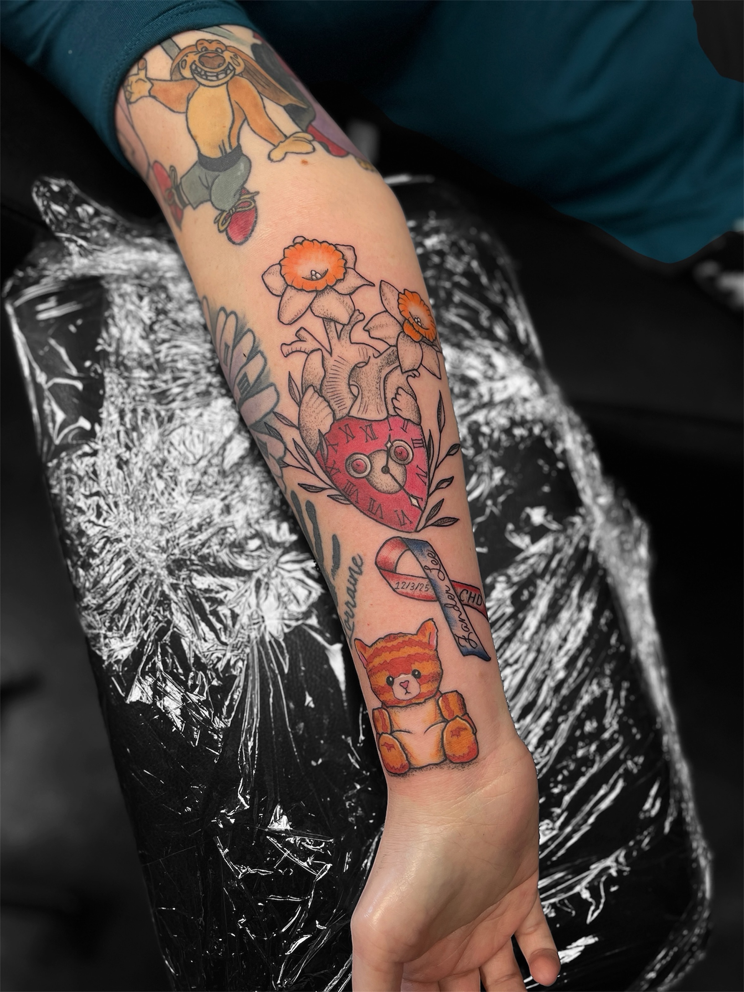 Teddy bear and flowers American traditional tattoo on the forearm by Brittany Ann Goff