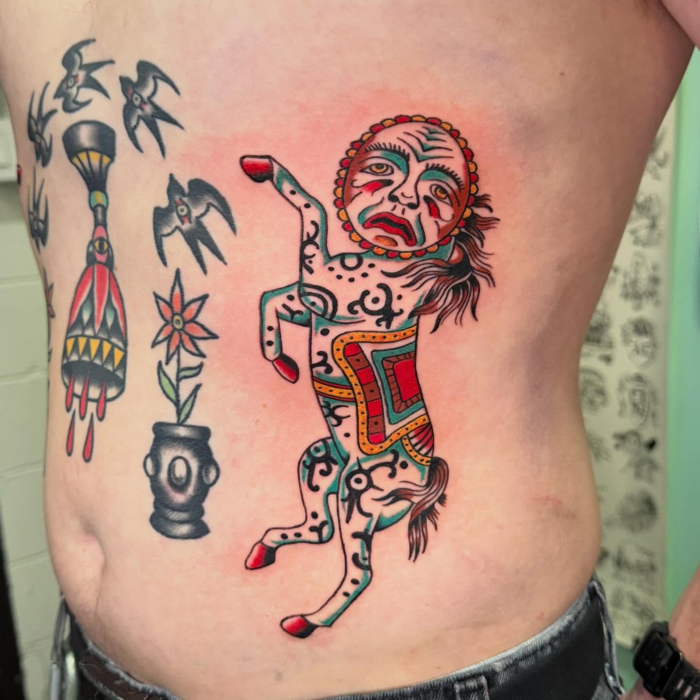 Dancer with birds American traditional tattoo on the ribs by charlie