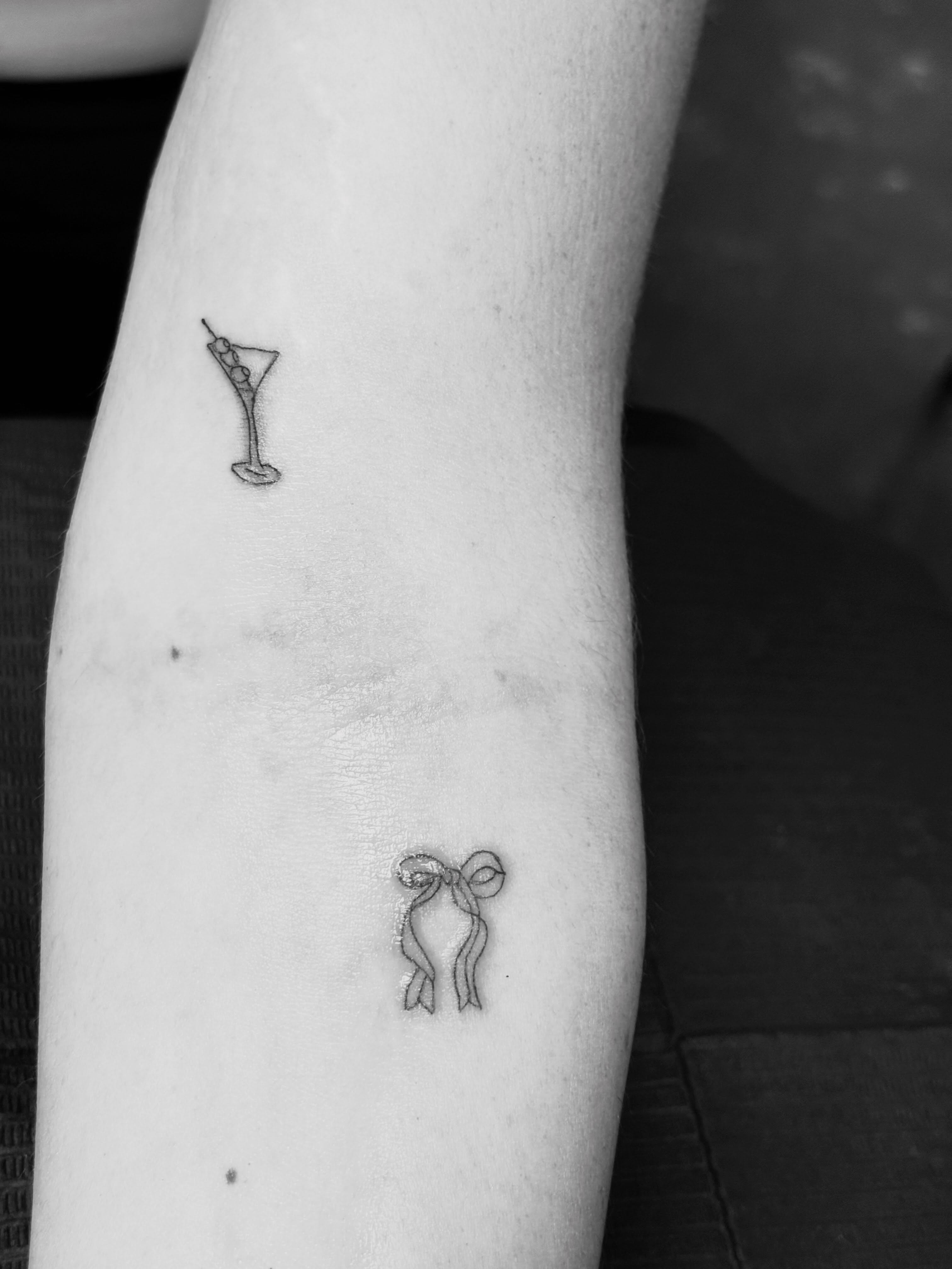 Martini glass fine line tattoo on the forearm by Malissa