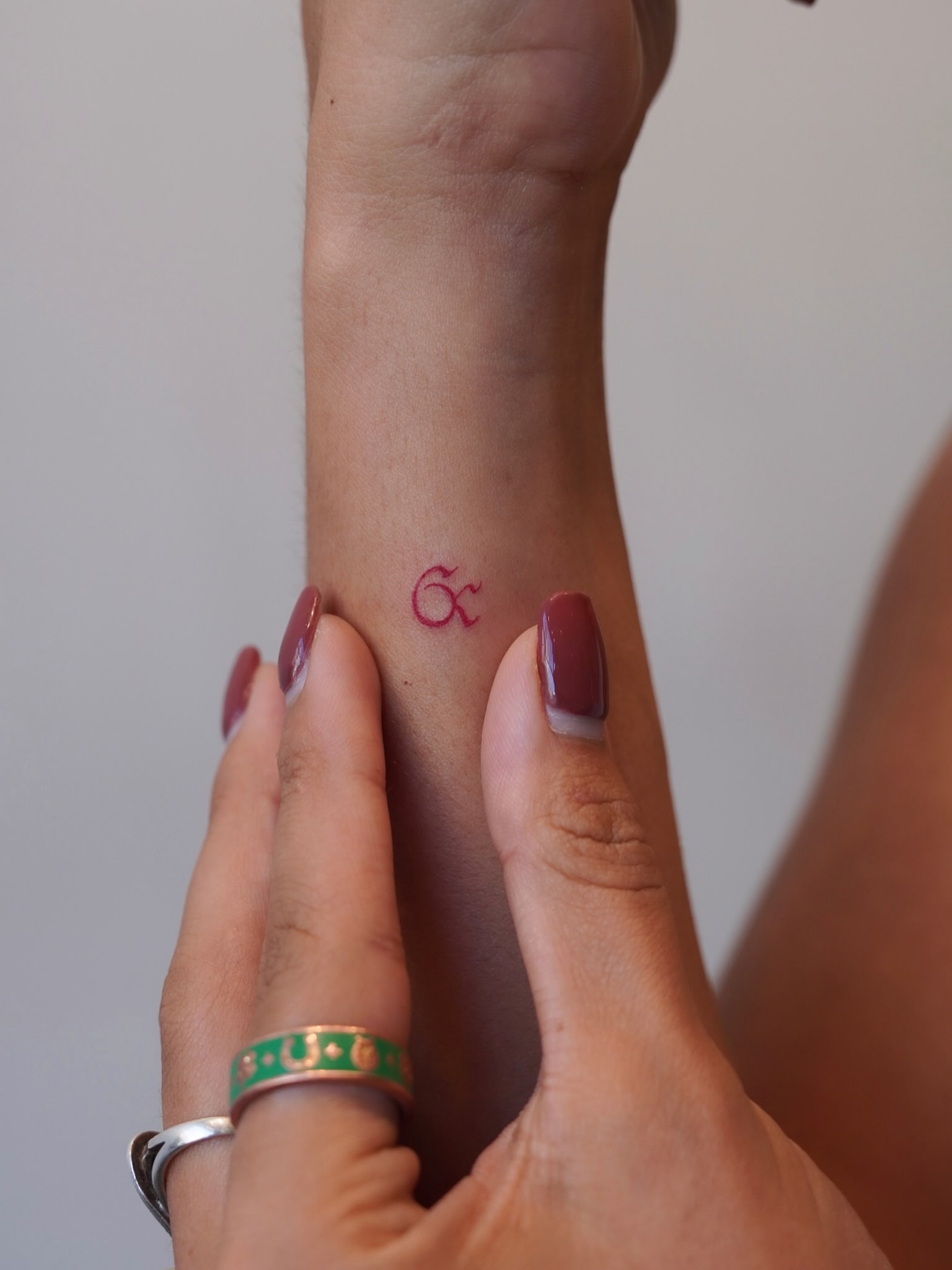 Love symbol lettering script tattoo on the forearm by Julia
