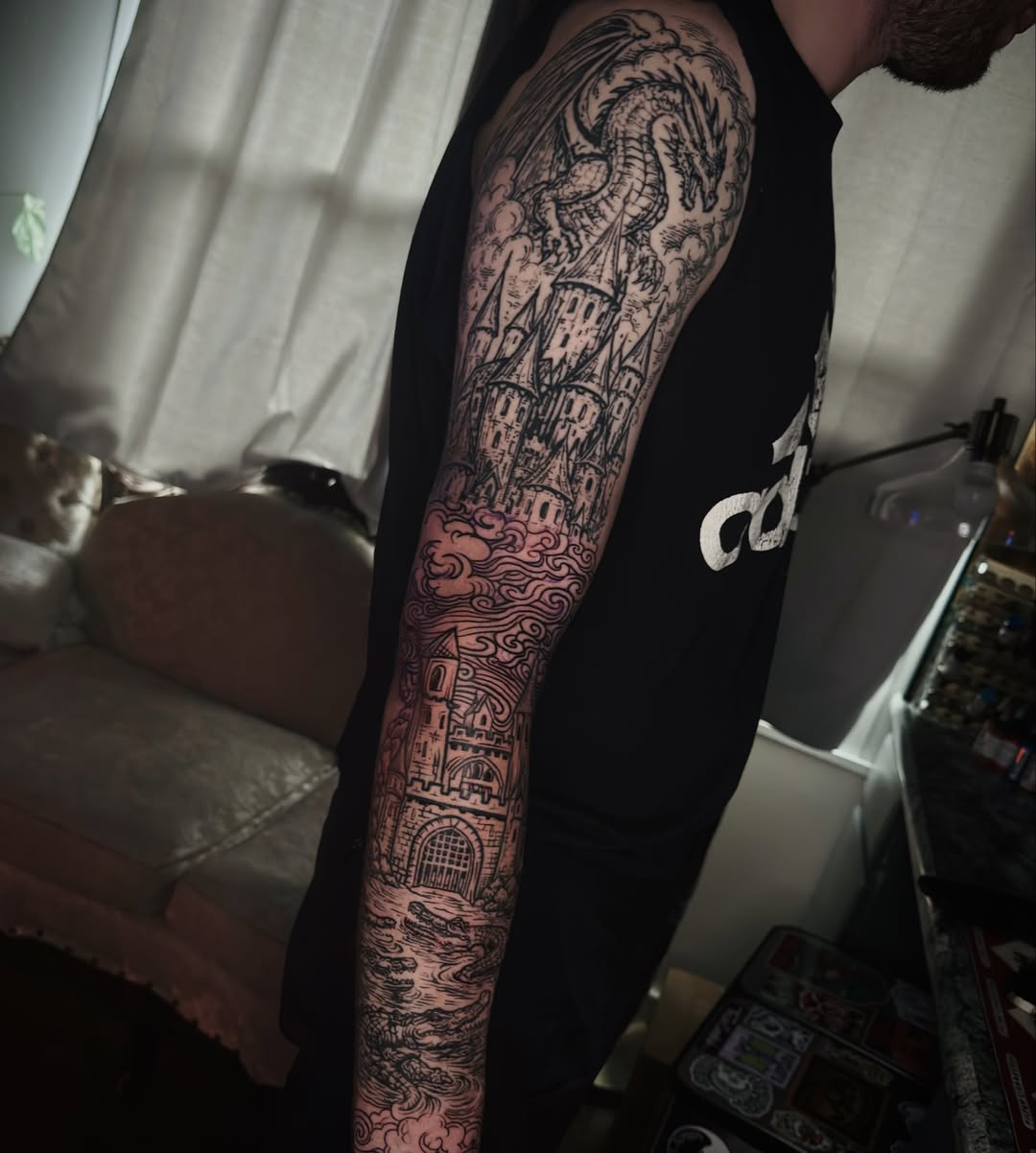 Castle and dragon black and grey tattoo on the forearm by Butz Tattoos