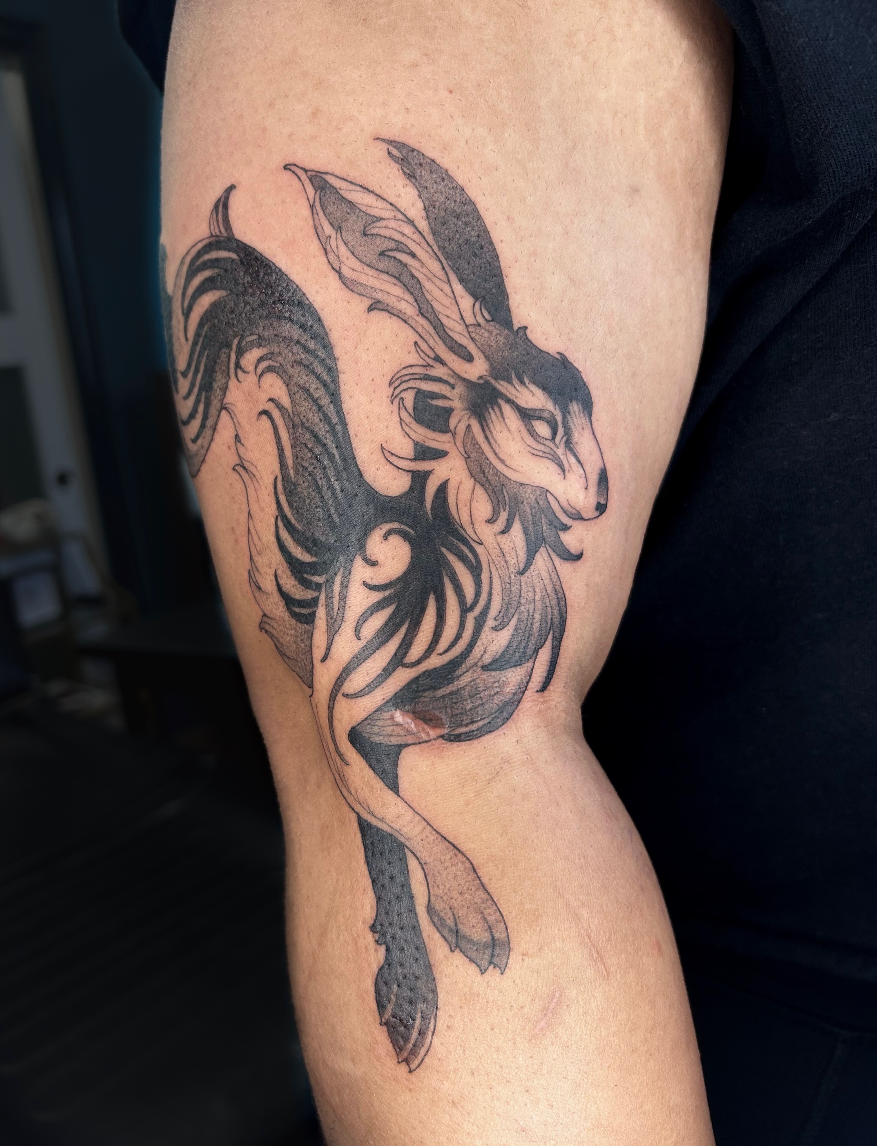 Goat black and grey tattoo on the forearm by Magnus