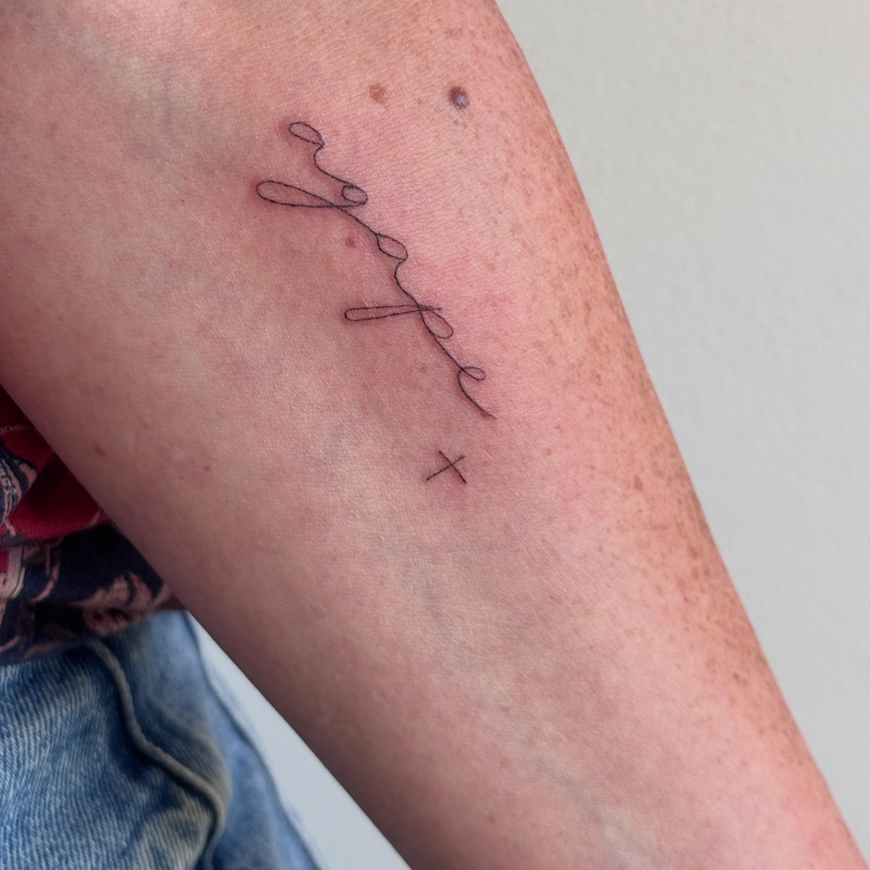 String fine line tattoo on the forearm by Malissa