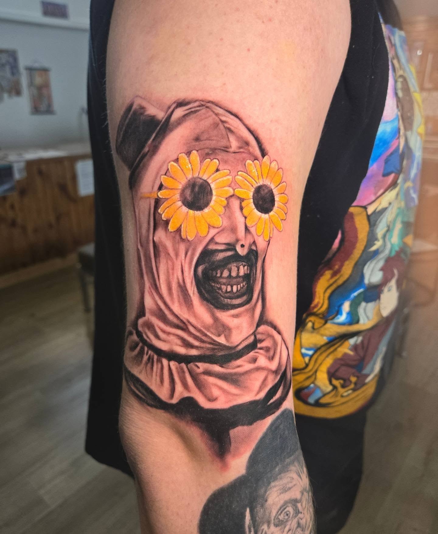 Clown with sunflowers realism tattoo on the forearm by Destiny