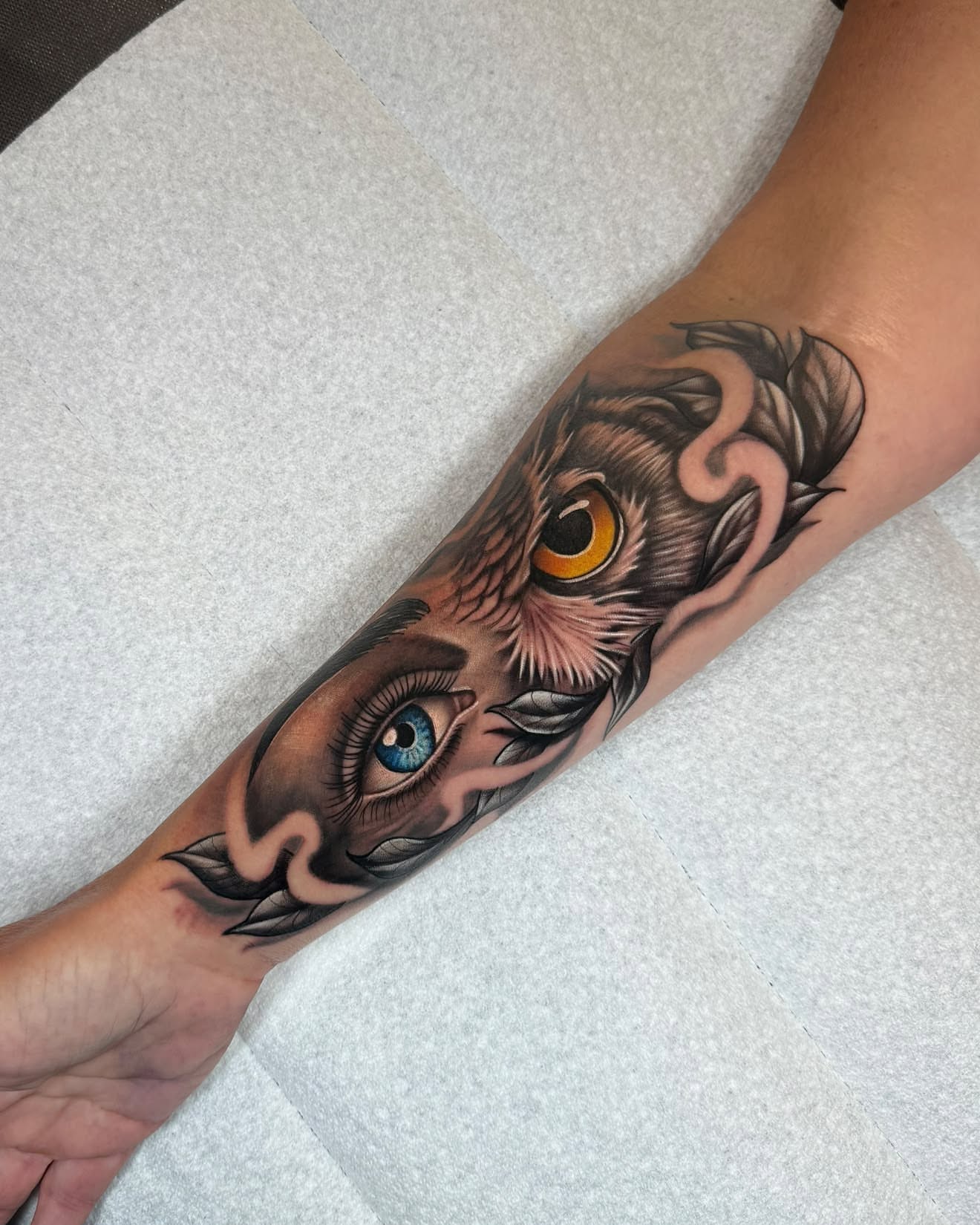 Owl and eye realism tattoo on the forearm by Chad Meado