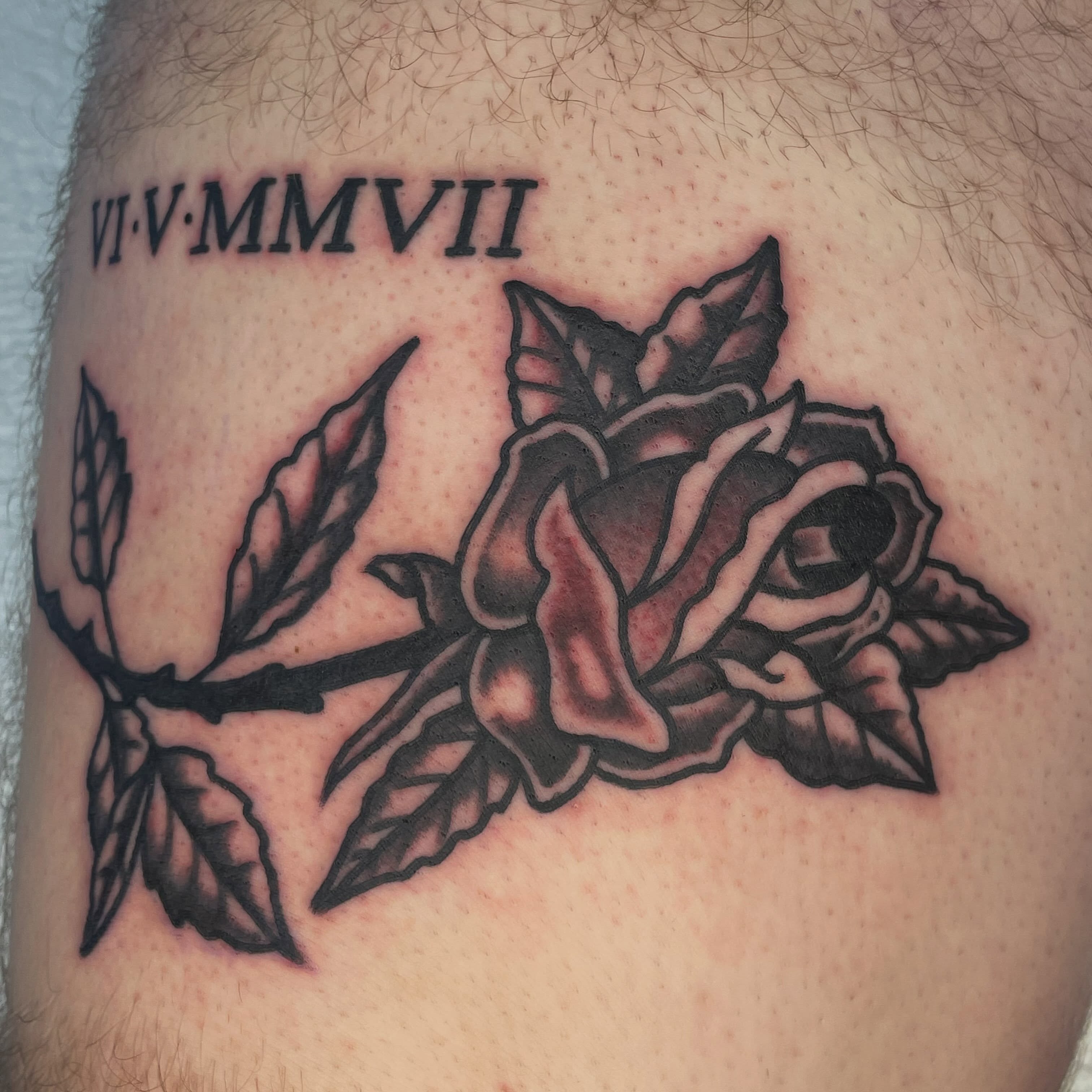 Rose black and grey tattoo on the upper arm by Nicholas M. Passeri