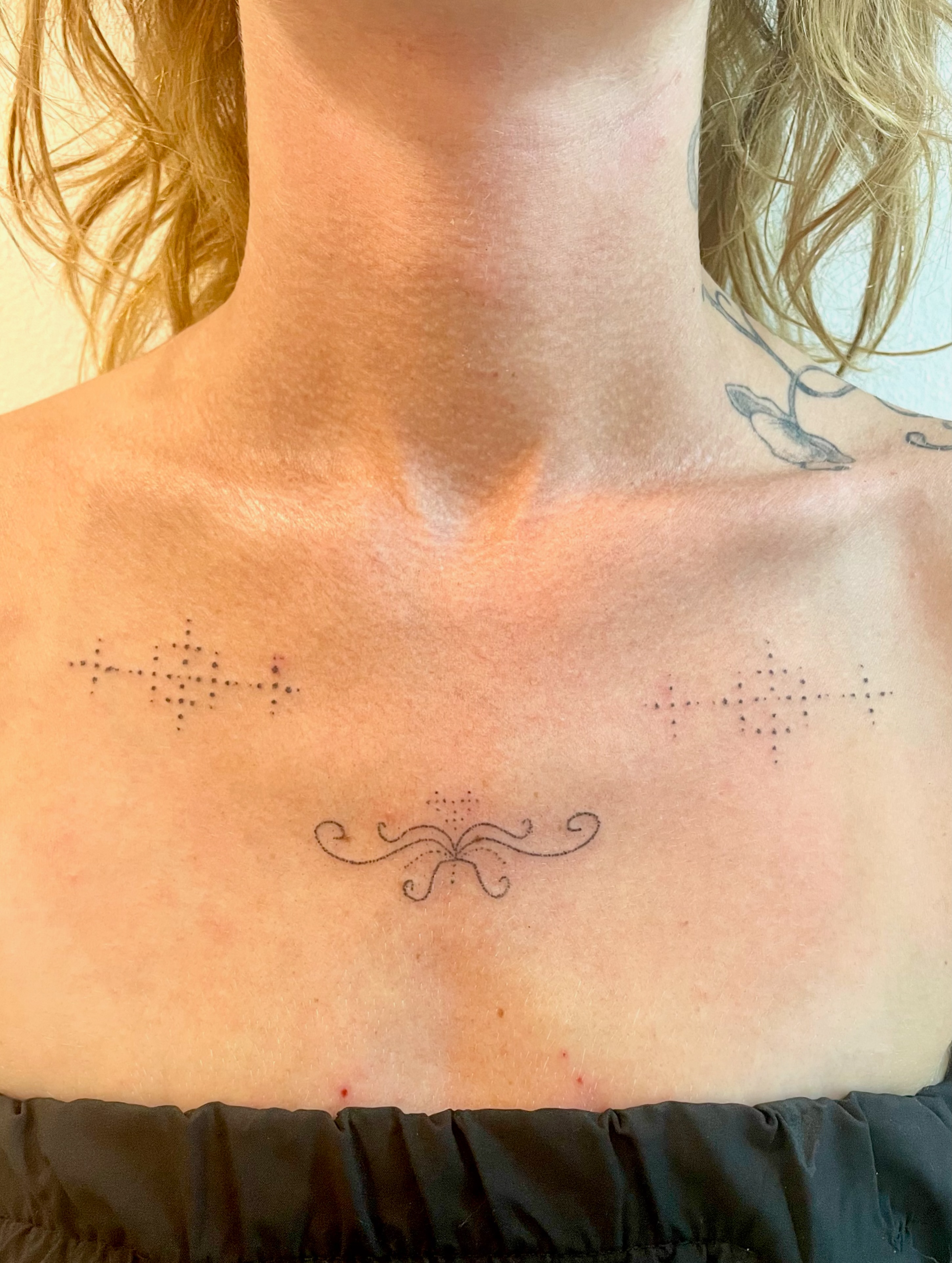 Crosses and swirl dotwork tattoo on the chest by Alyssa