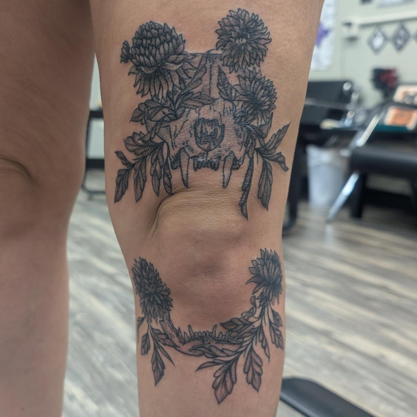 Skull with flowers black and grey tattoo on the forearm by Talia Zula, Loveland, Ohio