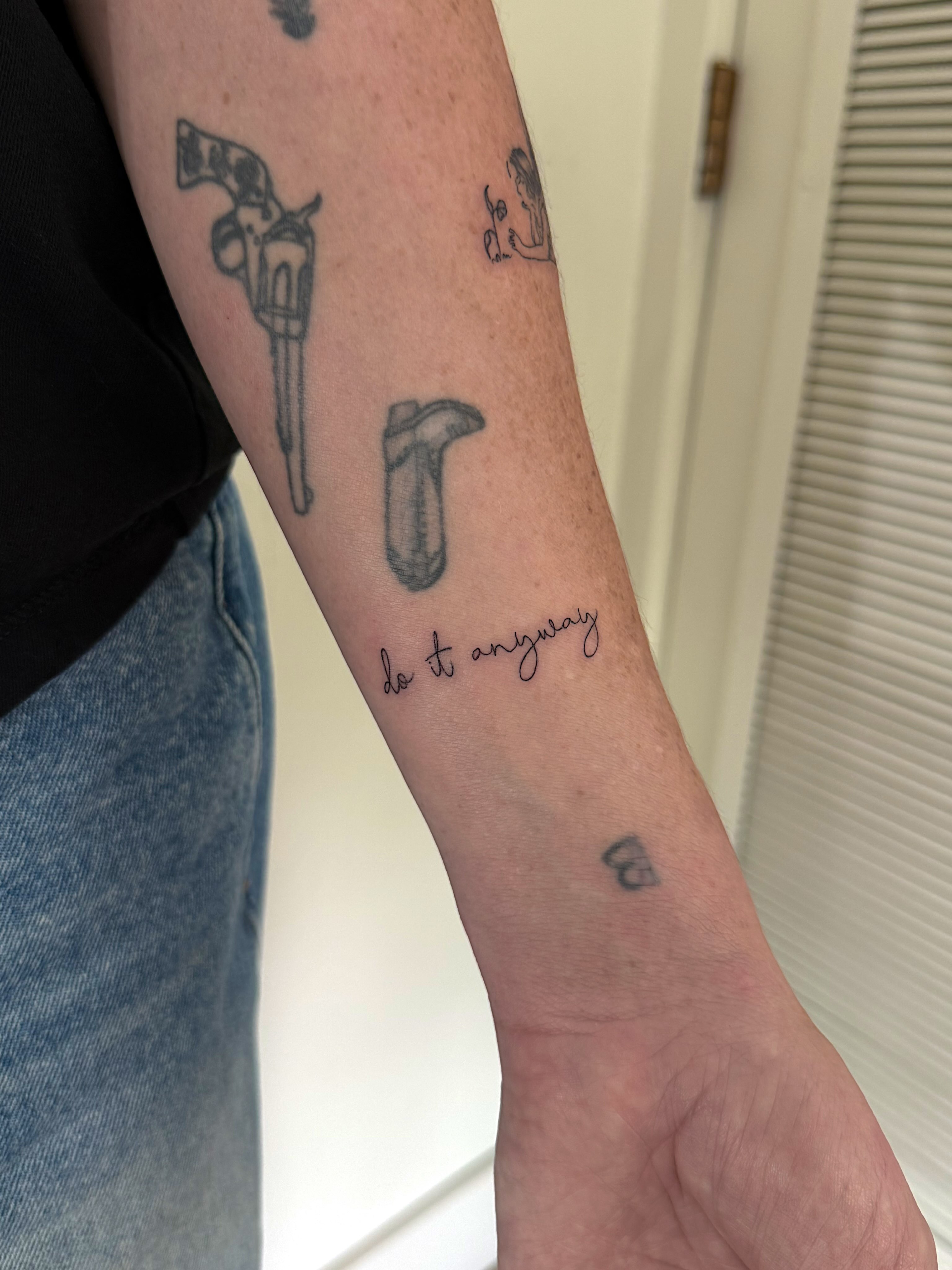 Revolver and quote black and grey tattoo on the forearm by Shelby Lynn Bayles, Ogden, Utah