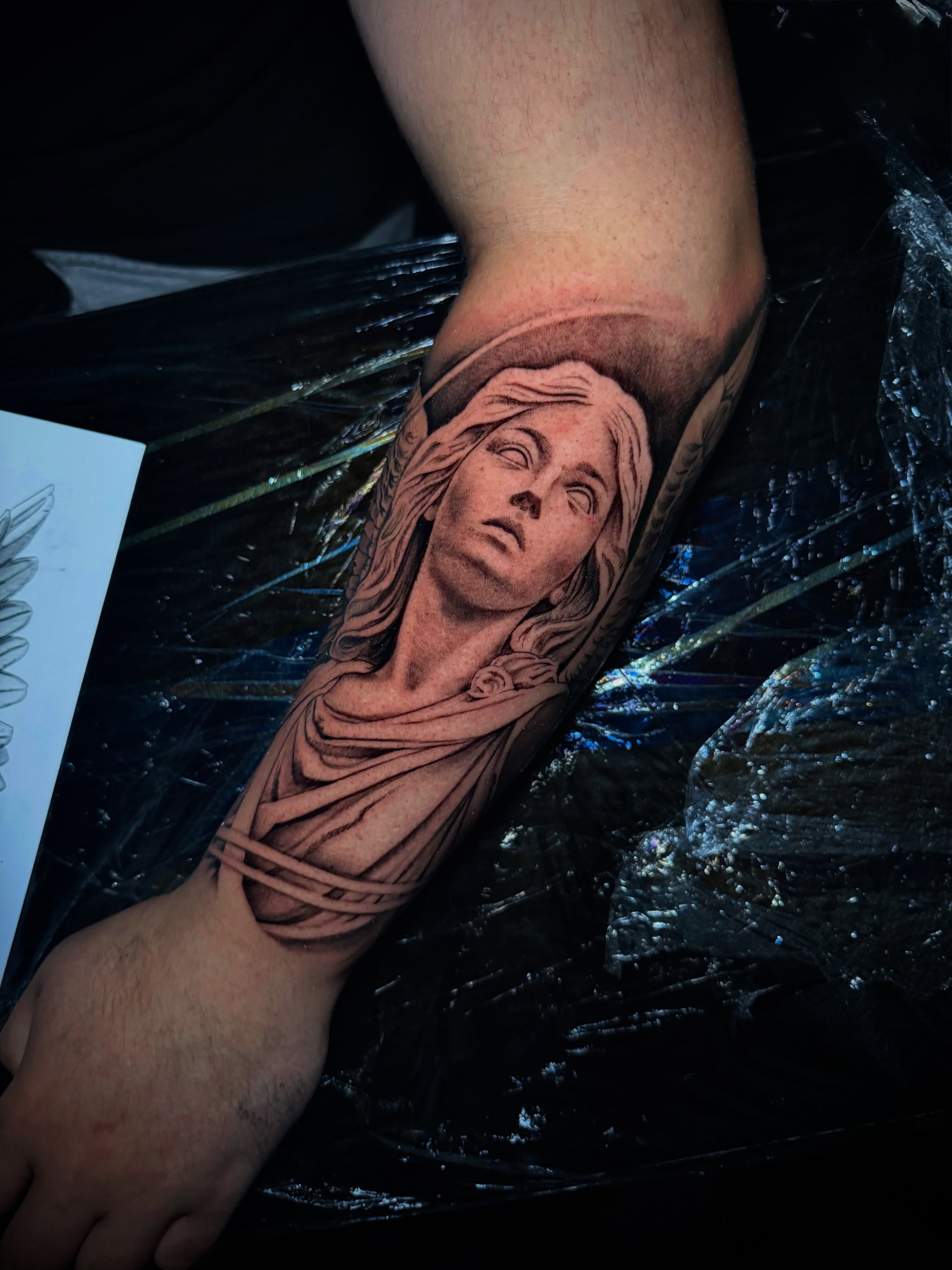 Woman's head realism tattoo on the forearm by Adam Newton