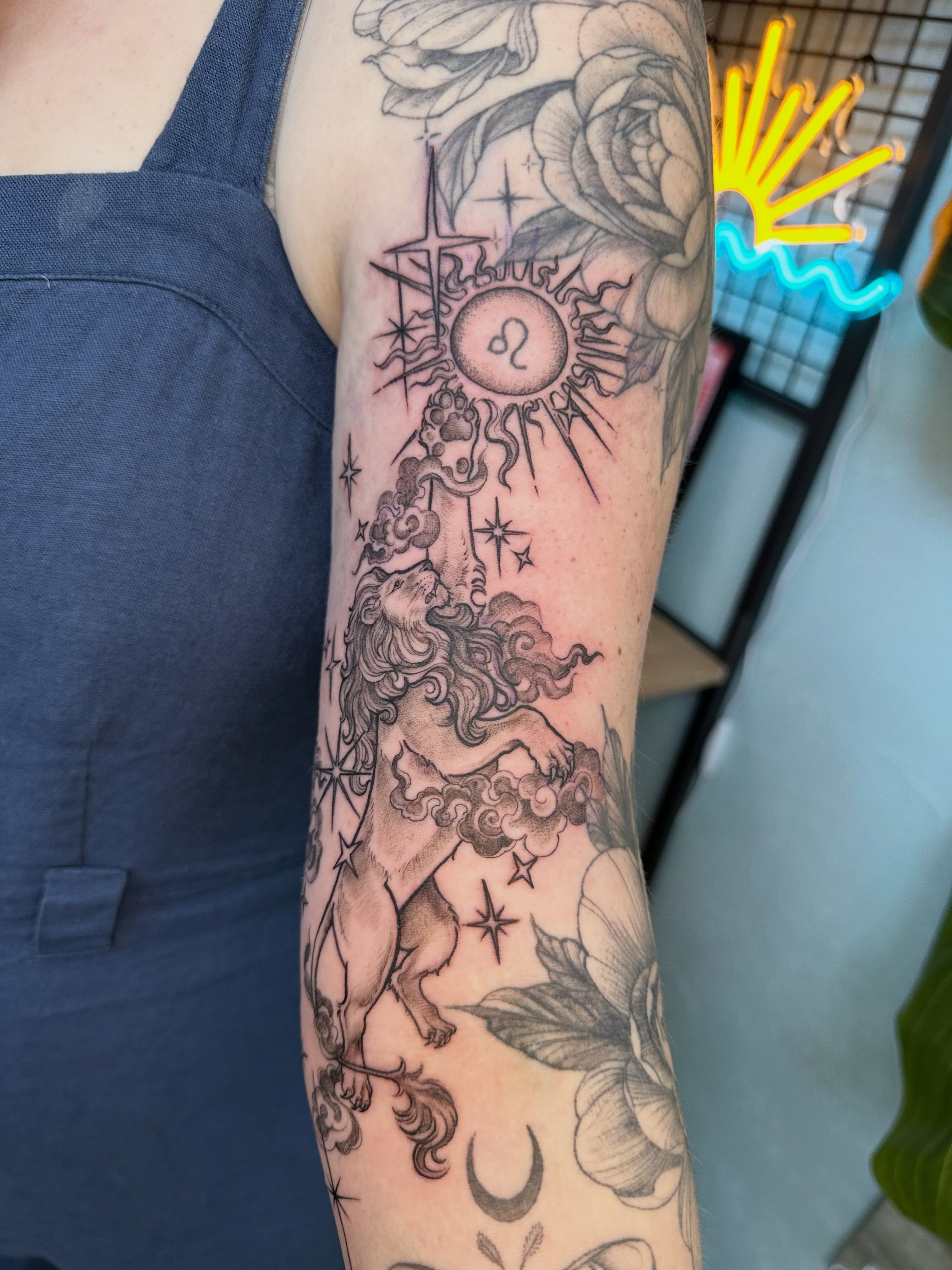 Lion and zodiac symbol black and grey tattoo on the forearm by ๐ฌ๐๐๐ฏ๐ ๐ฆ ๐๐ฉ๐ฆ๐ท๐๐๐ข๐ฑ๐ฅ ๐ซง๐ผ, Joplin, Missouri