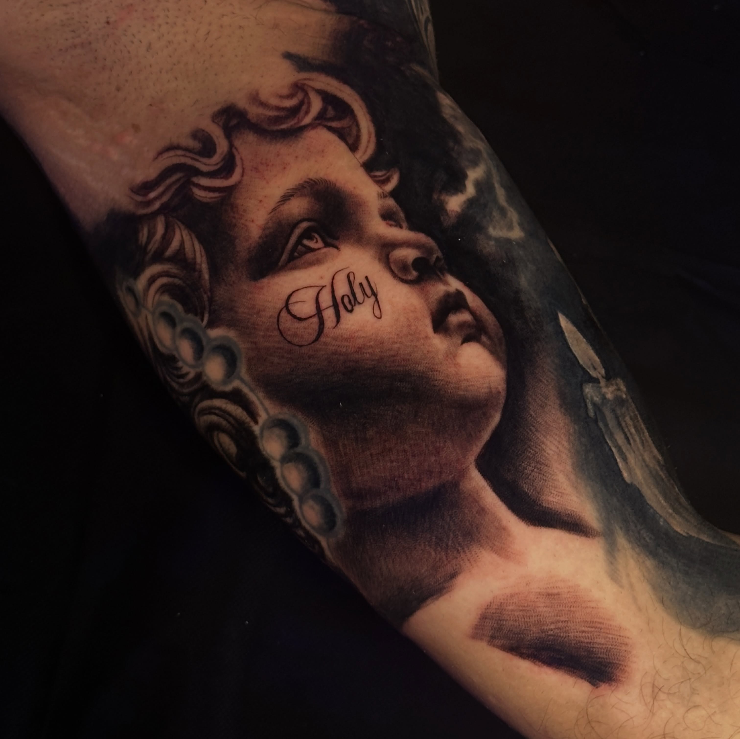 Angelic figure realism tattoo on the forearm by Dennis Alejandro