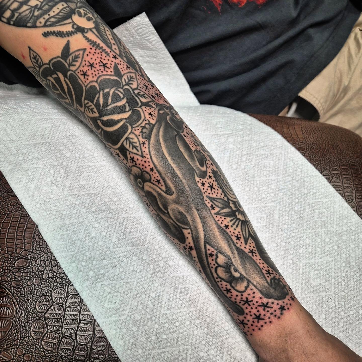 Floral and flame dotwork tattoo on the forearm by Taylor Popkins