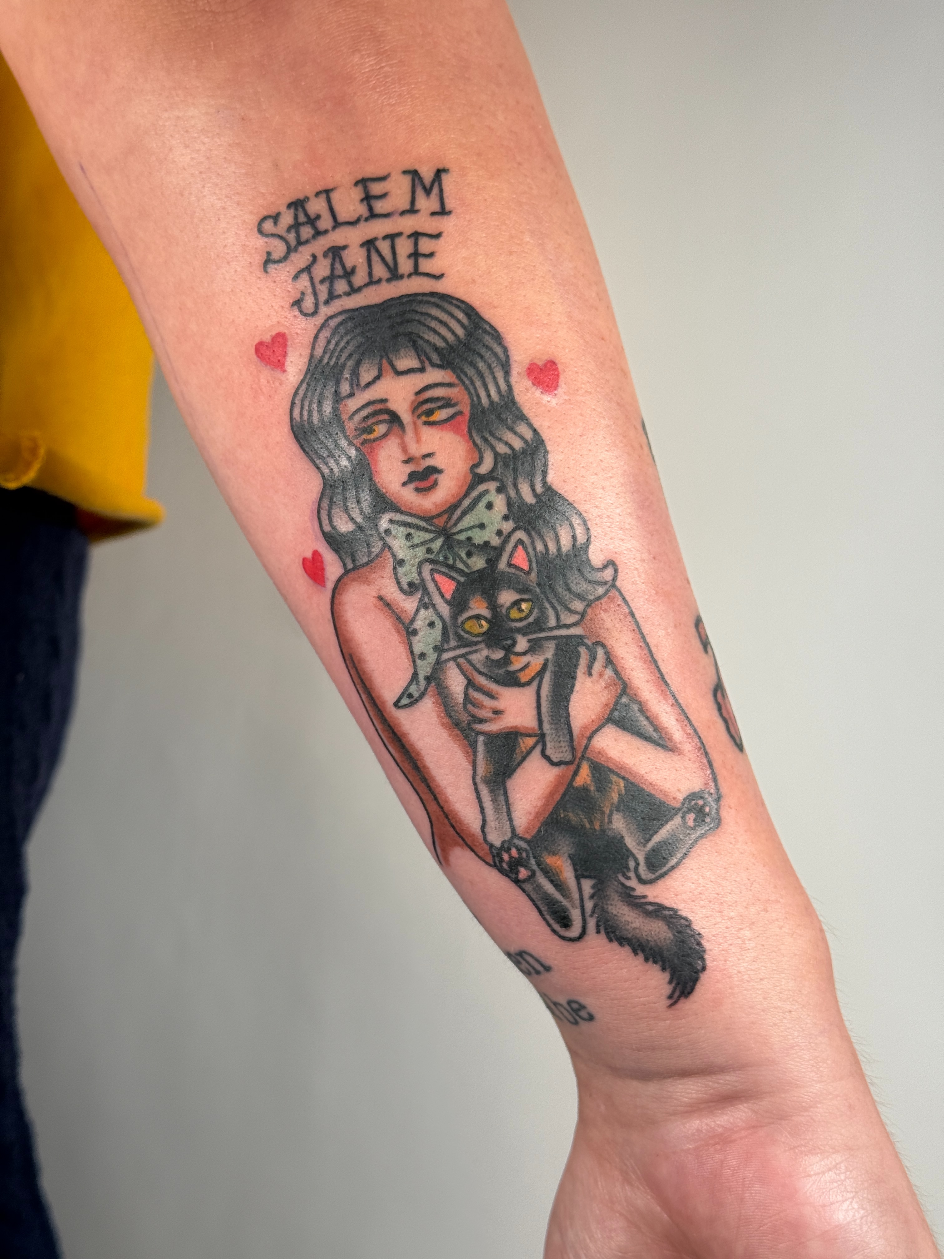 Girl with cat American traditional tattoo on the forearm by autumn sky