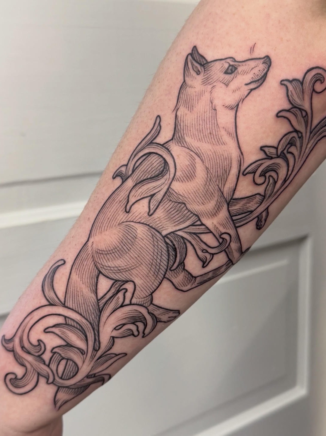 Dog and floral black and grey tattoo on the forearm by Taylor 🍂☕️