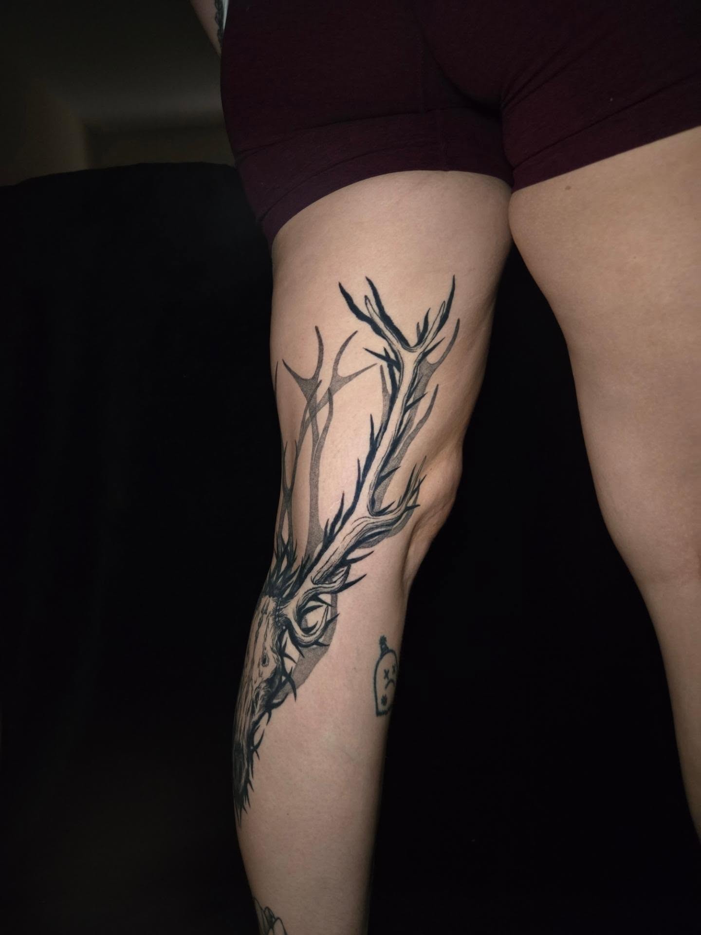 Stag head black and grey tattoo on the thigh by Perry