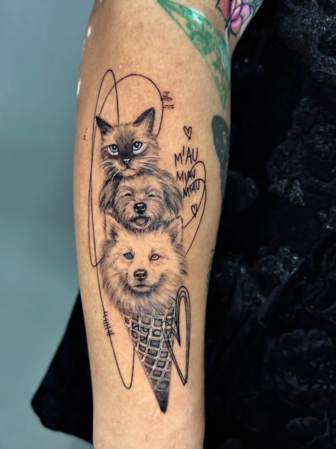 Ice cream cone with animals realism tattoo on the forearm by Fabian Hellberg