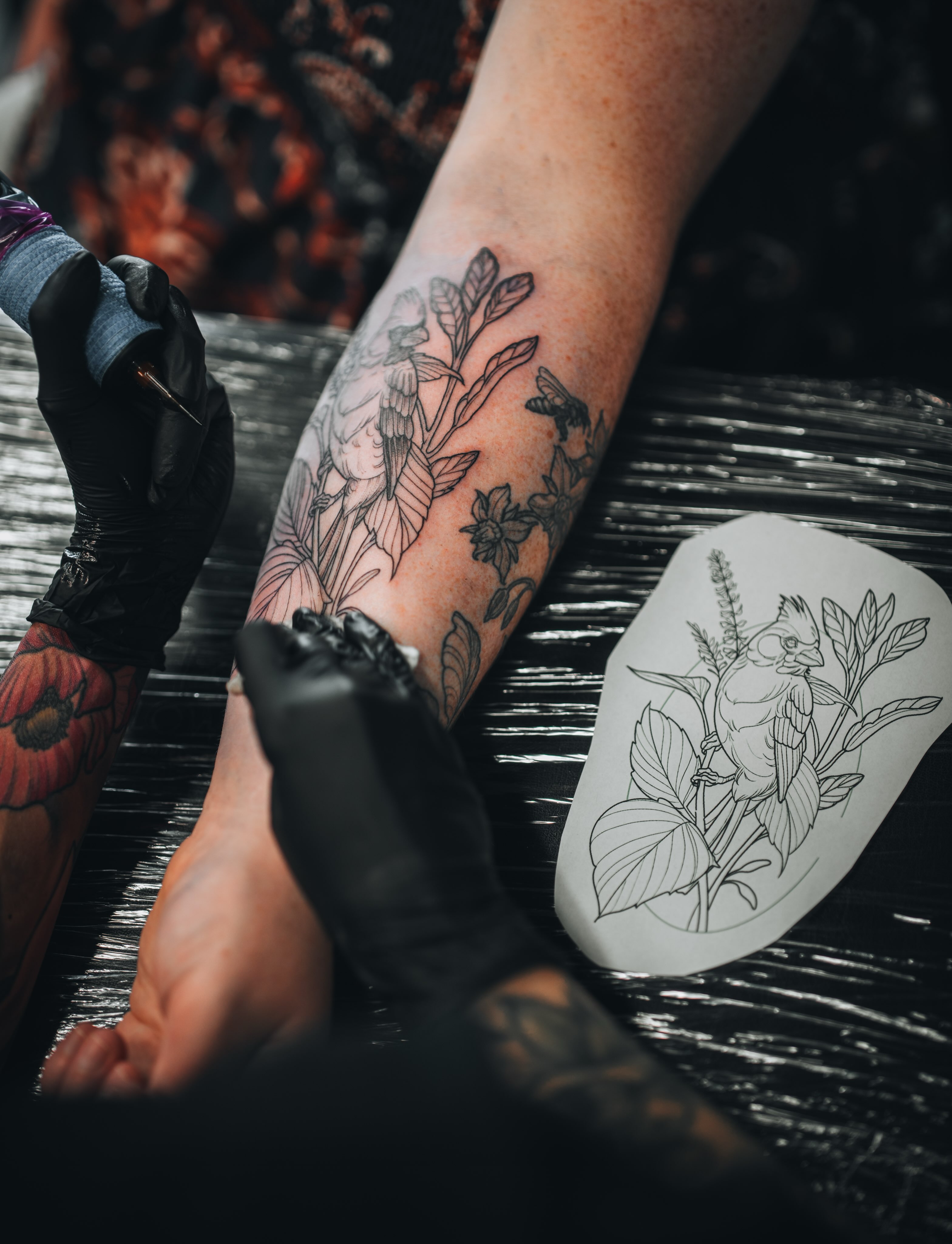 Bird and floral black and grey tattoo on the forearm by Kirsten Marsden Ballantyne