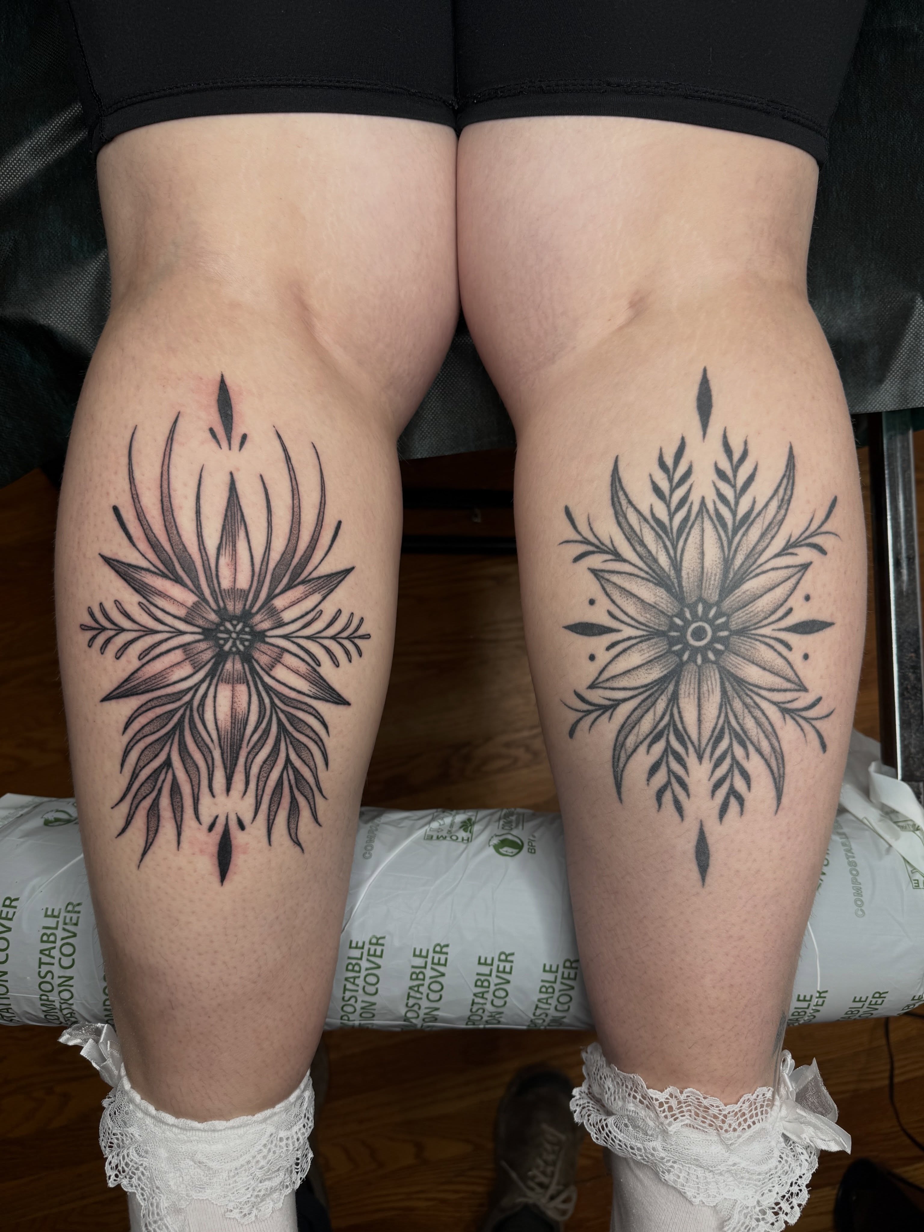 Snowflake black and grey tattoo on the thigh by Paul DeVay