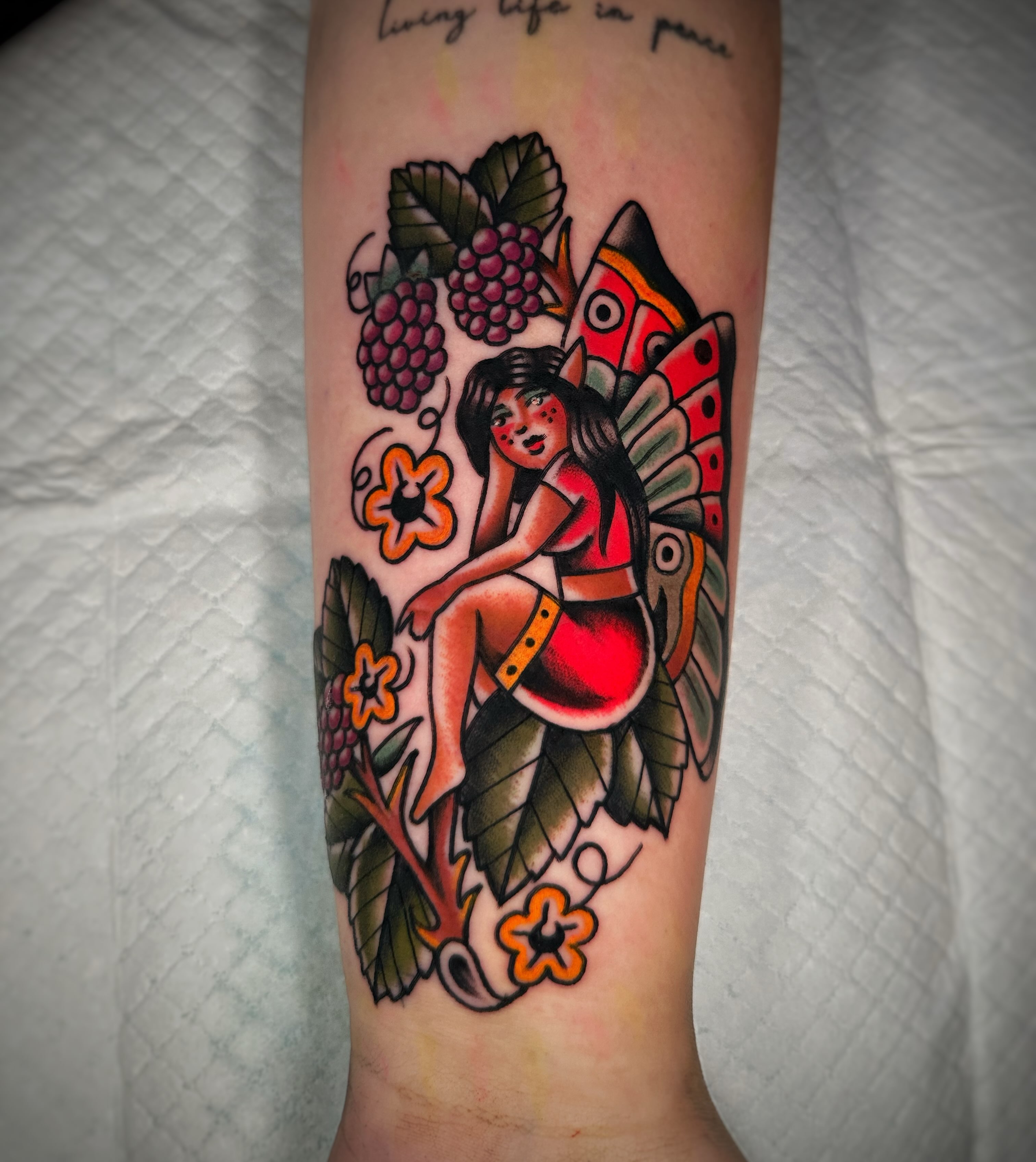 Female figure with butterfly wings American traditional tattoo on the forearm by Alex Finnerty, Reading, Massachusetts