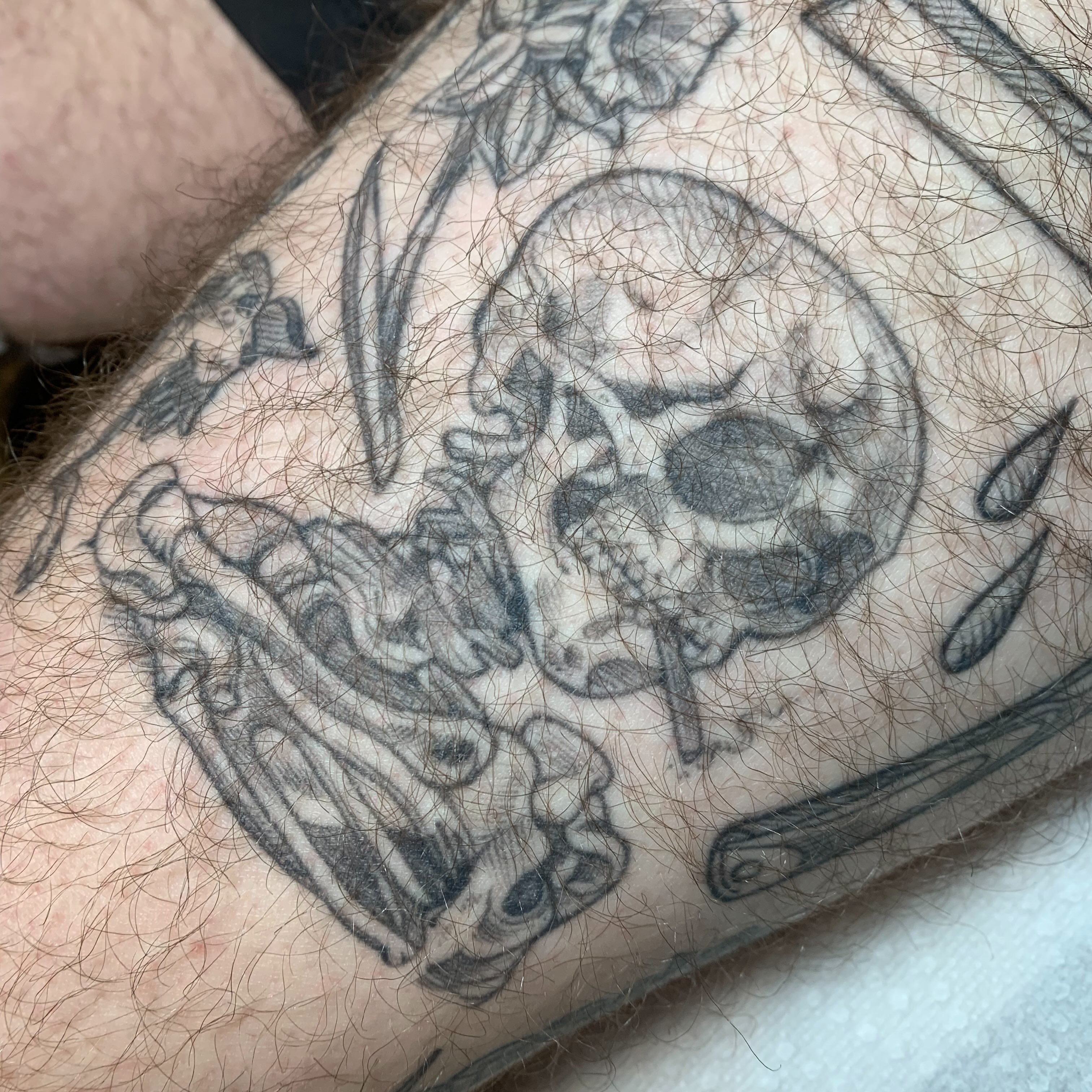 Skull and dragon American traditional tattoo on the forearm by Tabby Wirebach, Kutztown, Pennsylvania