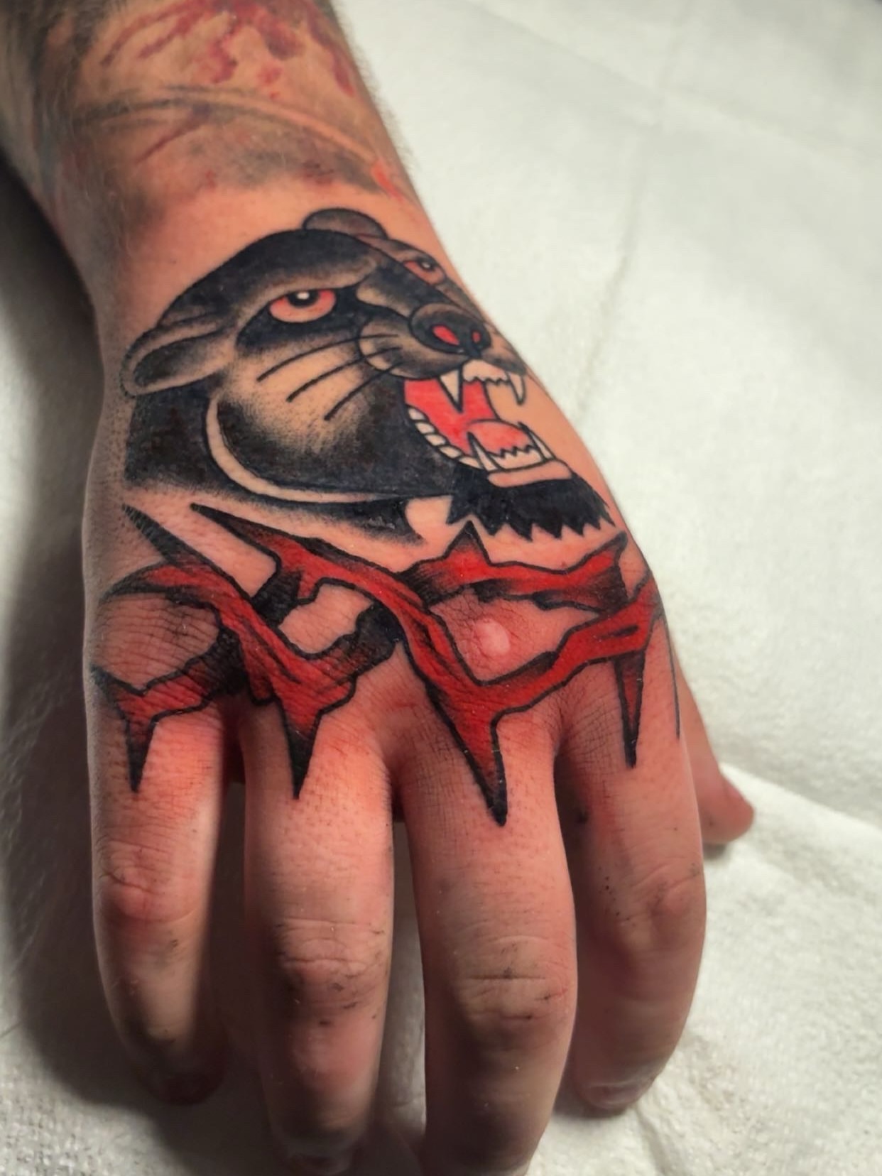 Ferret American traditional tattoo on the hand by Chris Prince Jr., Miamisburg, Ohio