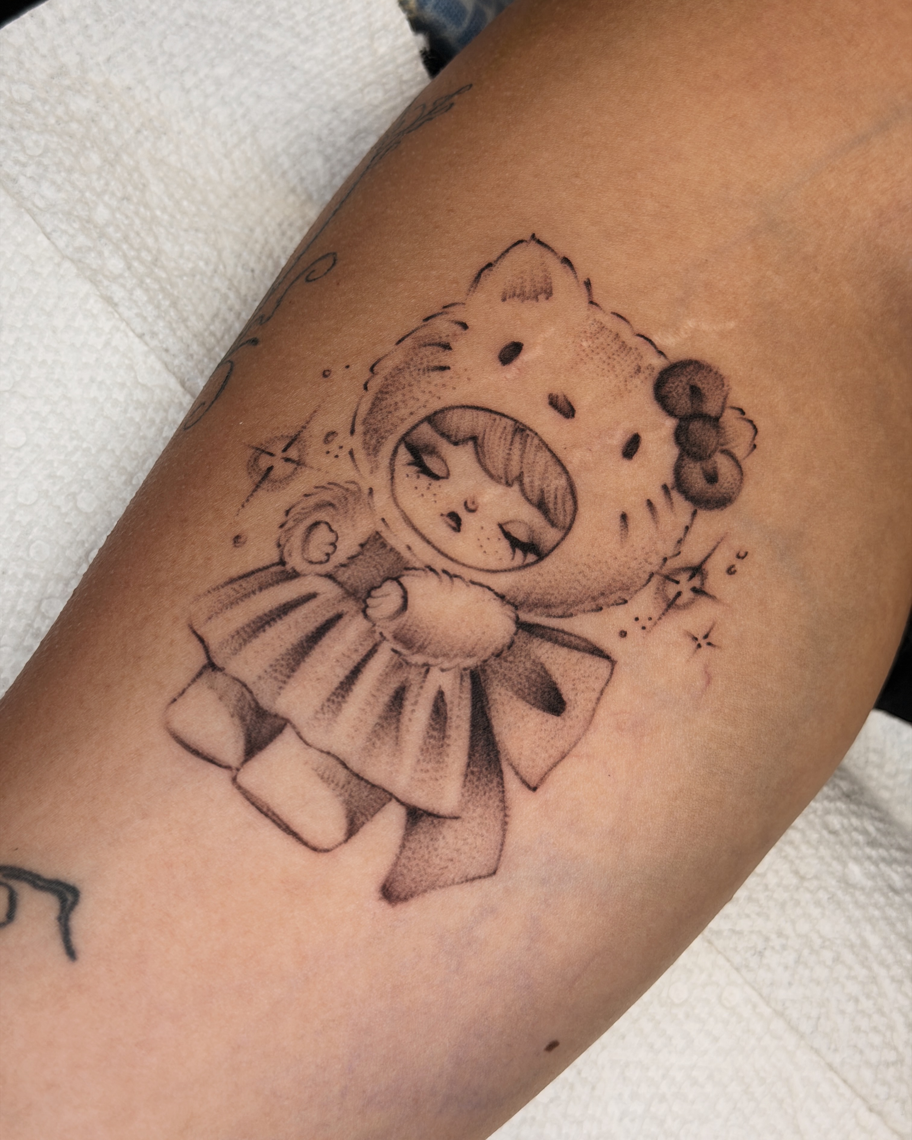 Hello kitty black and grey tattoo on the forearm by 💞Juju💕