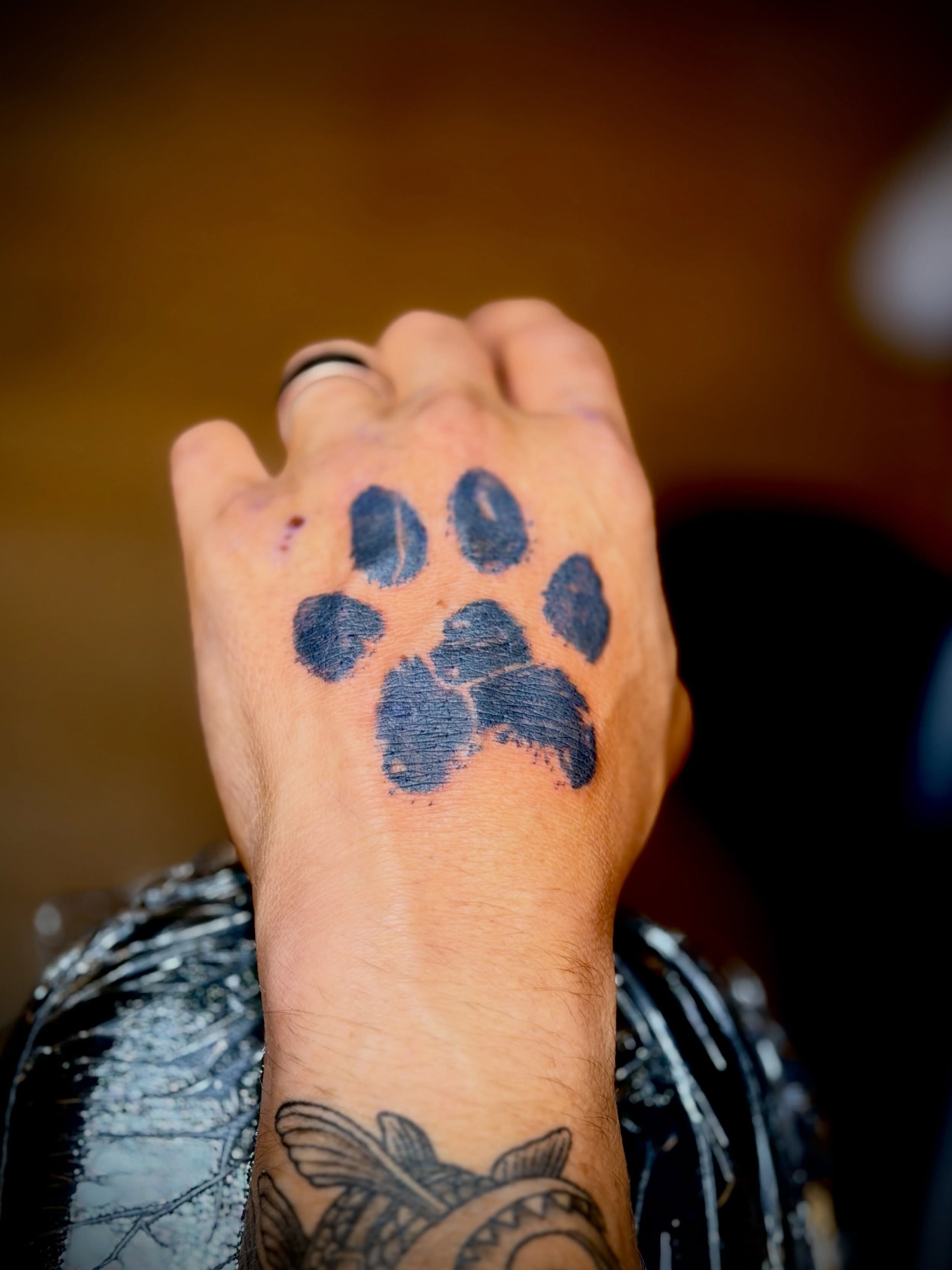 Paw print dotwork tattoo on the hand by Joshua Ware, Alvarado, Texas